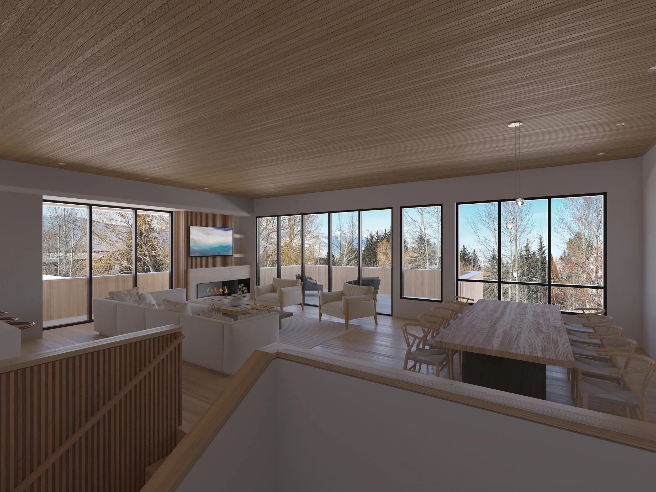 Jackson Development in Jackson, Wyoming. Living room with large windows, a white sofa, wooden chairs, a wall-mounted TV, and a mountain view outside.