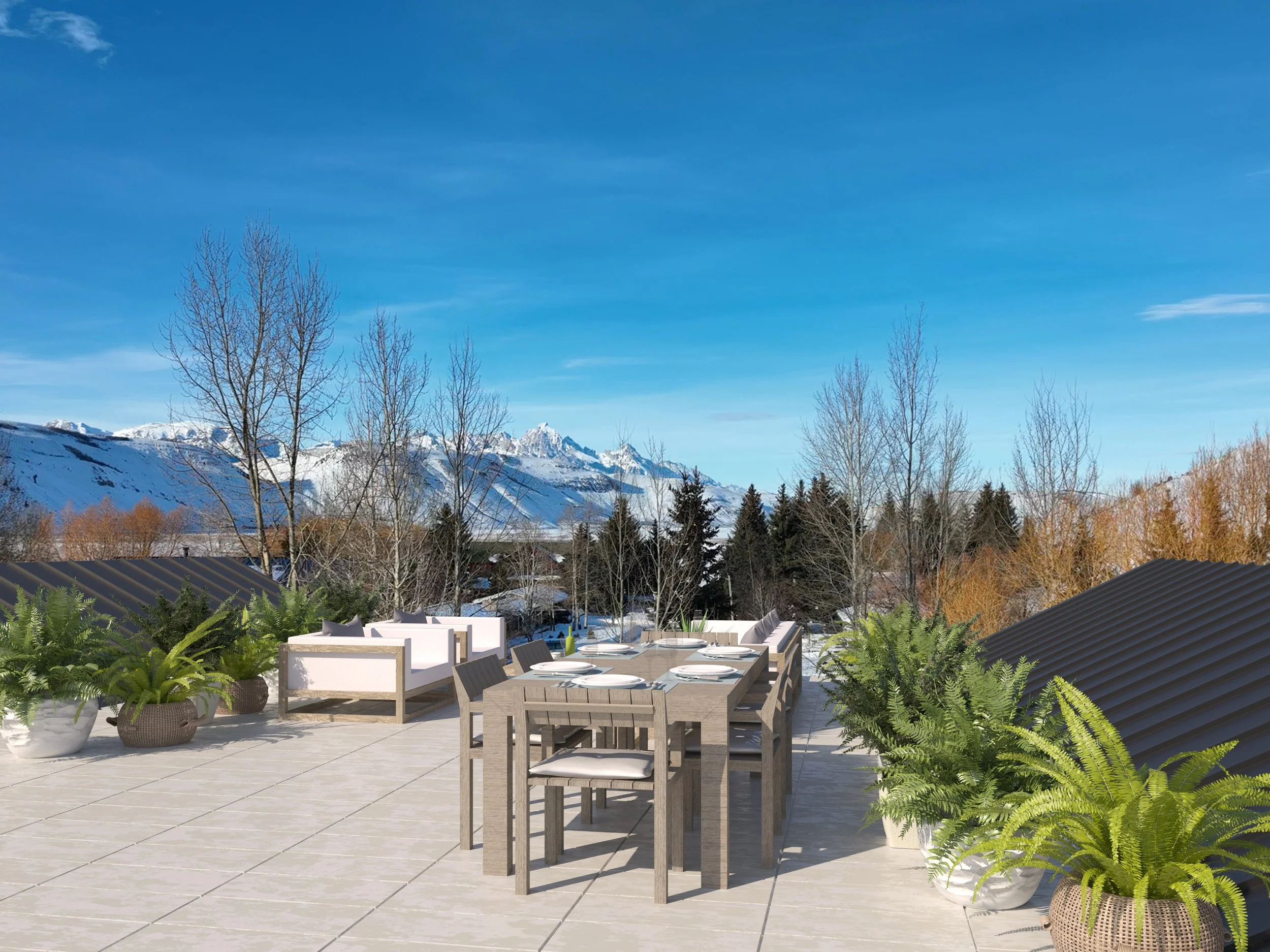 Jackson Development in Jackson, Wyoming. Outdoor patio with dining table set for six, surrounded by potted plants, overlooking snow-covered mountains and a clear blue sky.