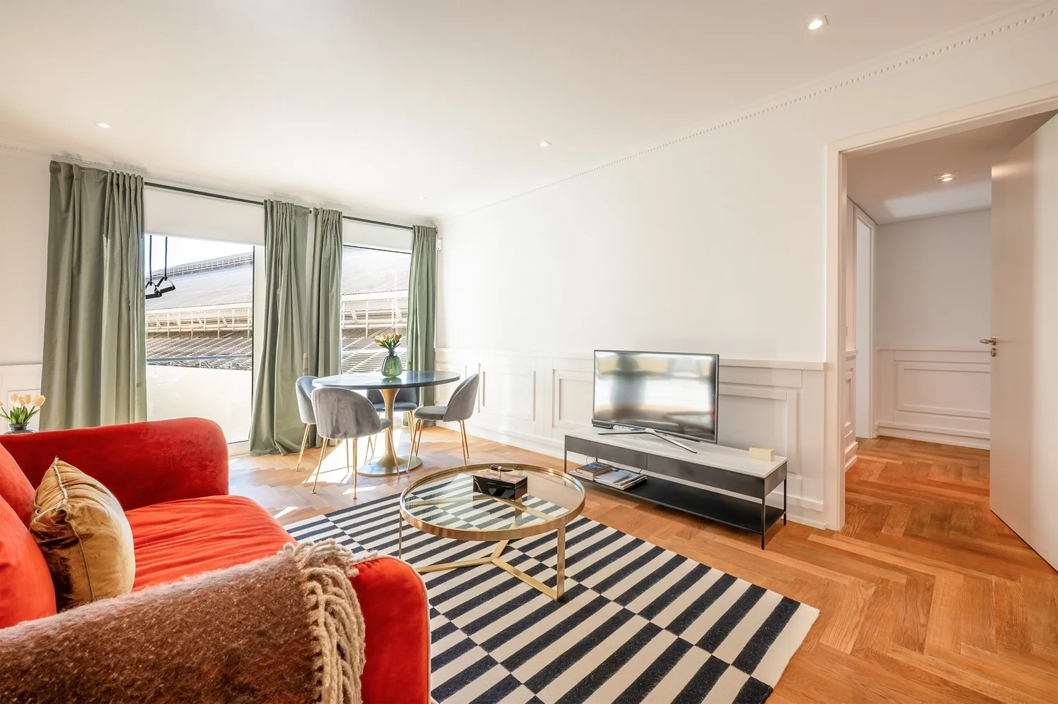 Light-filled living room with a red sofa