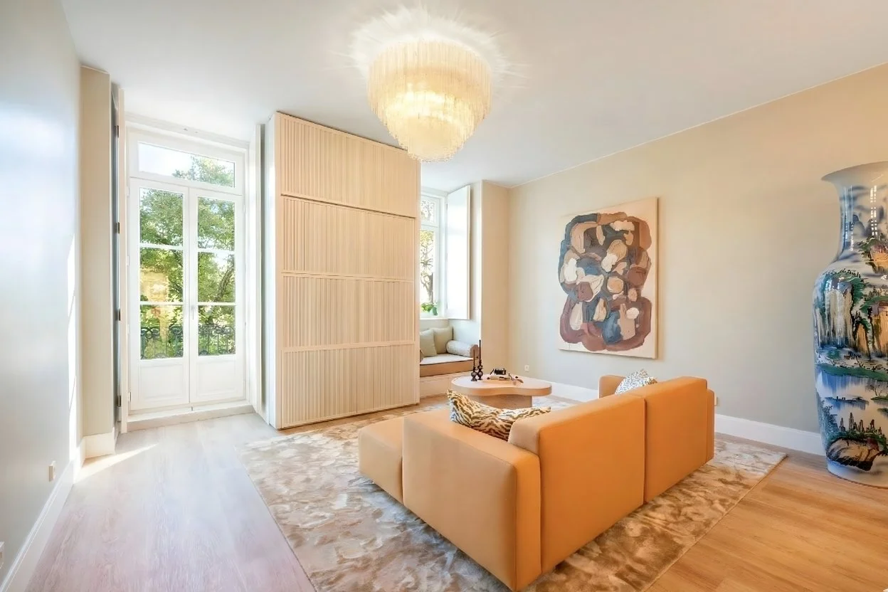 Living room with an orange sofa in a renovated Lisbon apartment