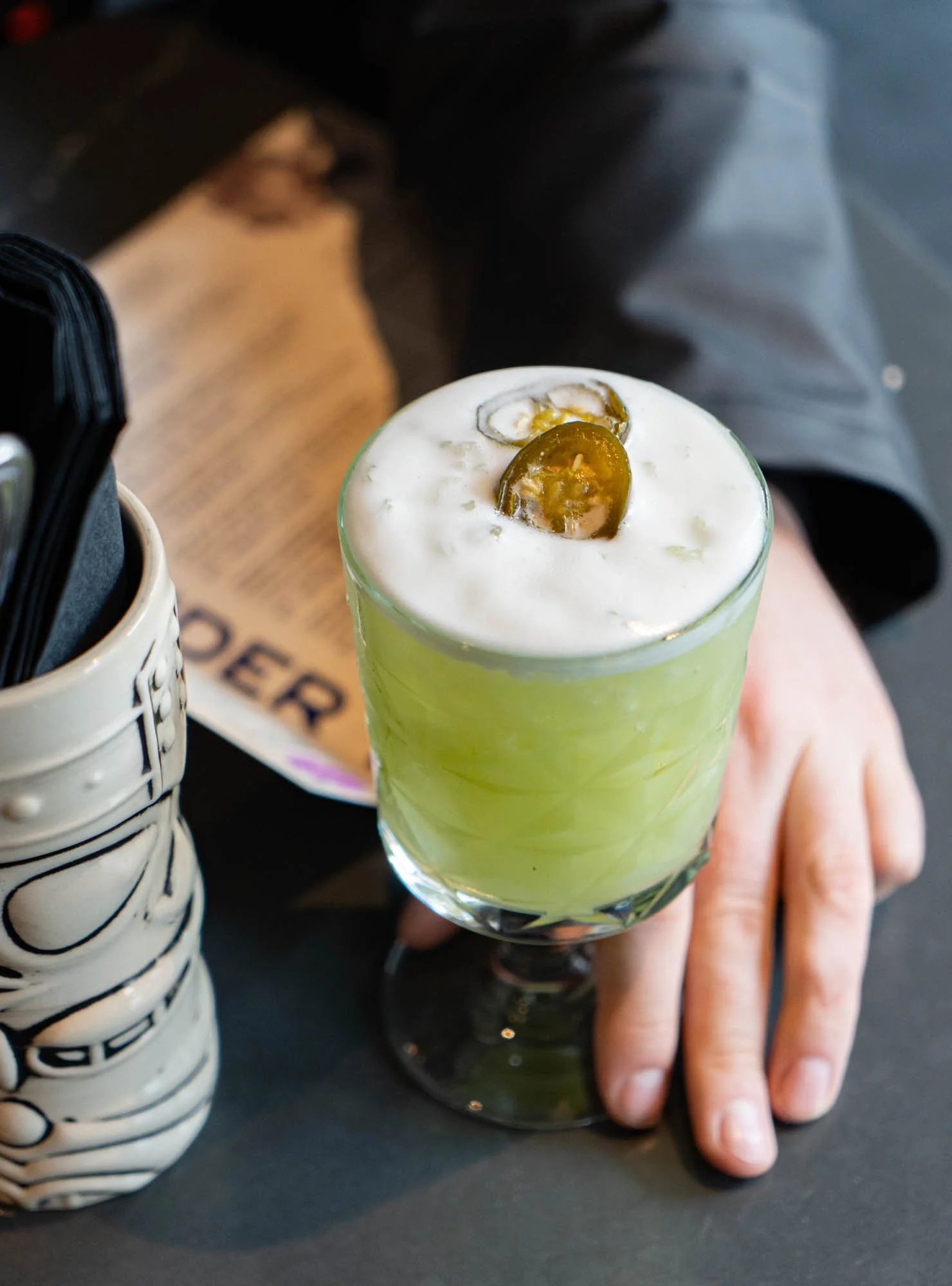 A martini cocktail with olives