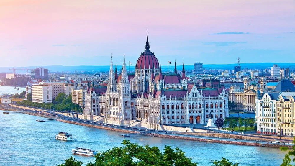 Budapest skyline at sunset showing historic buildings of the city and the river