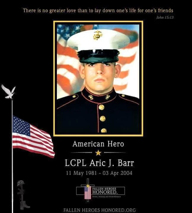 Memorial tribute for LCPL Aric J. Barr, a Marine in uniform with a serious expression, set against a background of the American flag. Text includes a quote from John 15:13, his birth and death dates, and indicates he is an American hero honored by fallenheroeshonored.org.