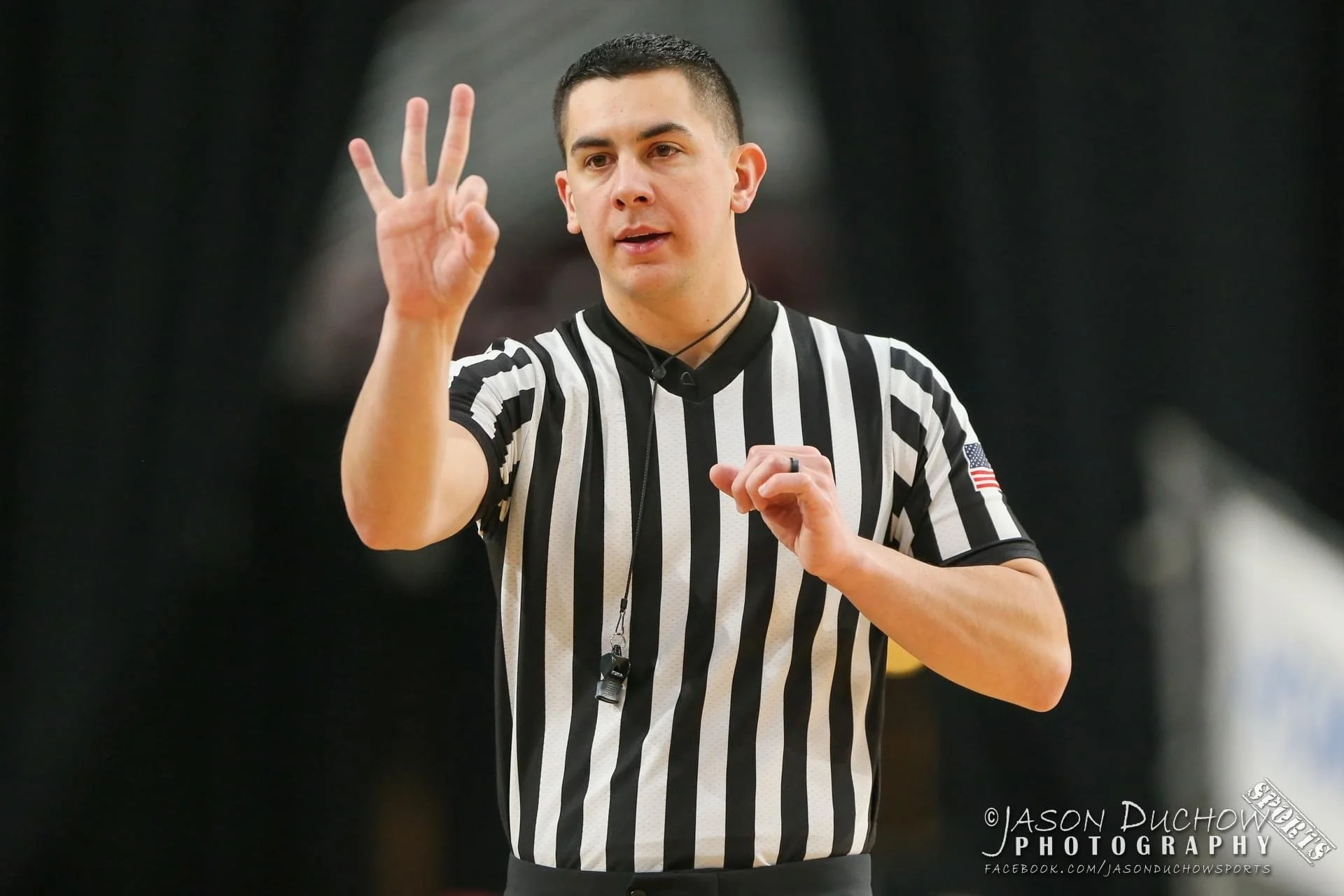 Ben Allen on the basketball court as referee calling a 3 point shot.