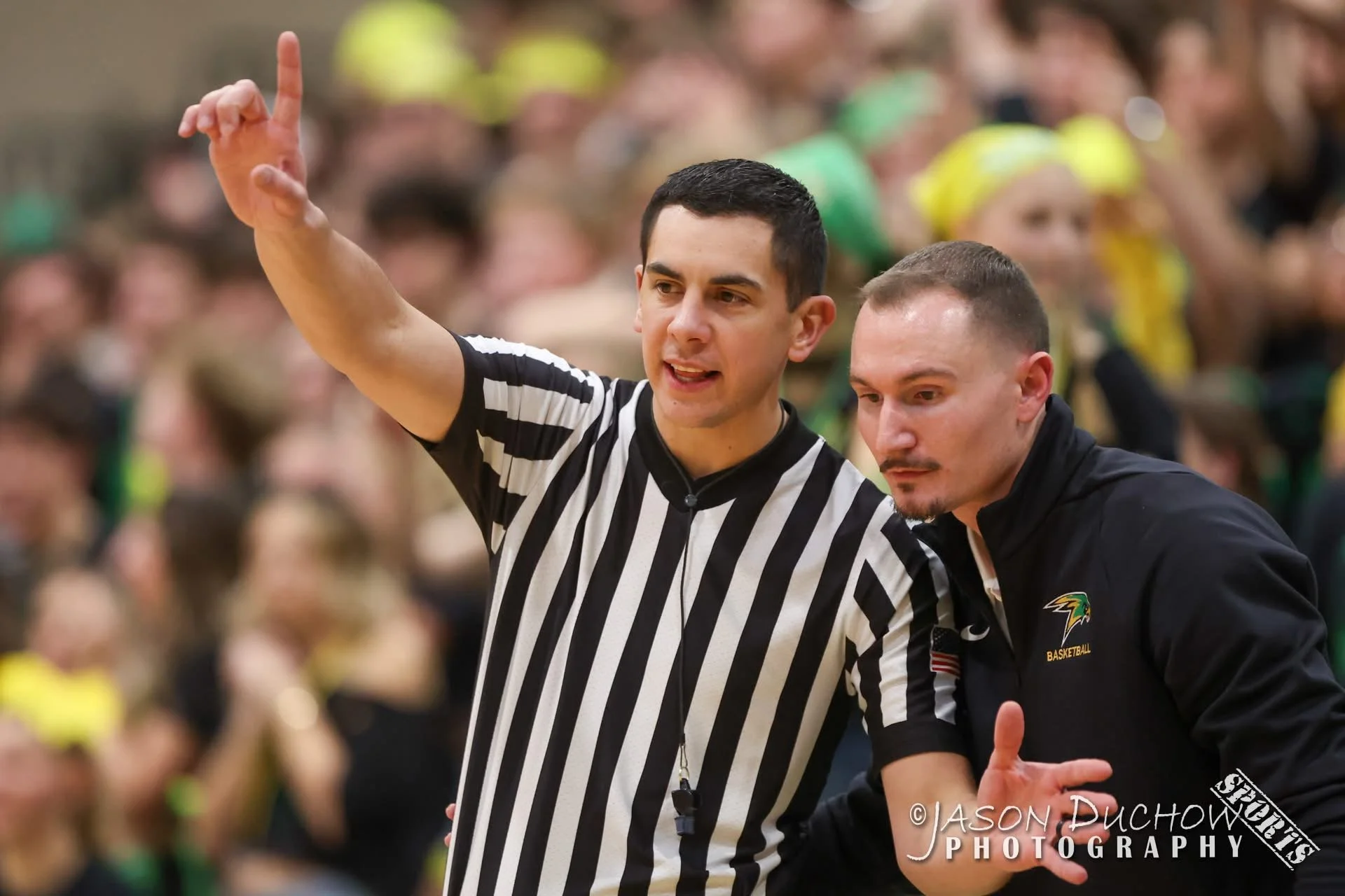 Ben Allen as referee on the baseketball court with a team coach