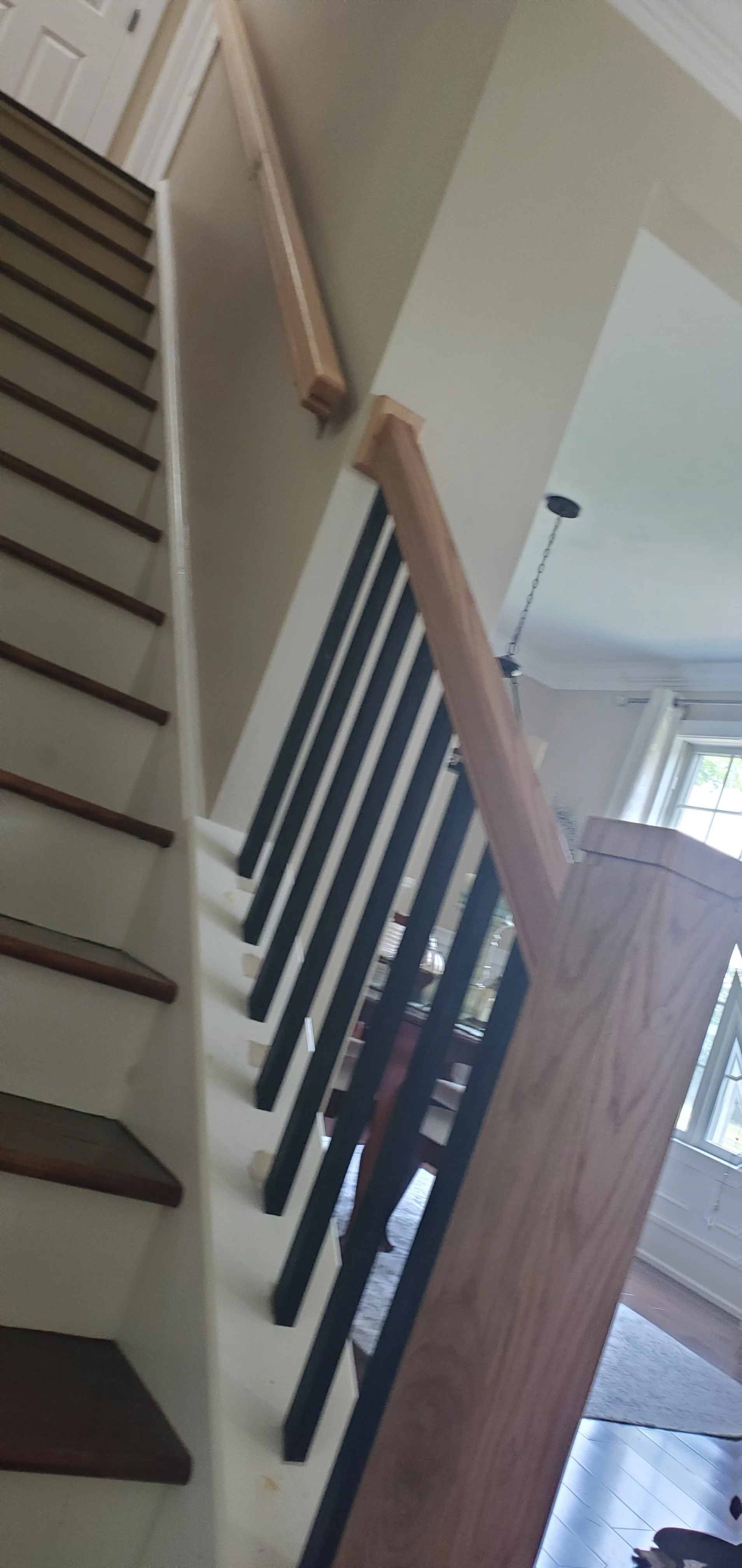 Lower level custom oak railing and handrail reconfigured newel post