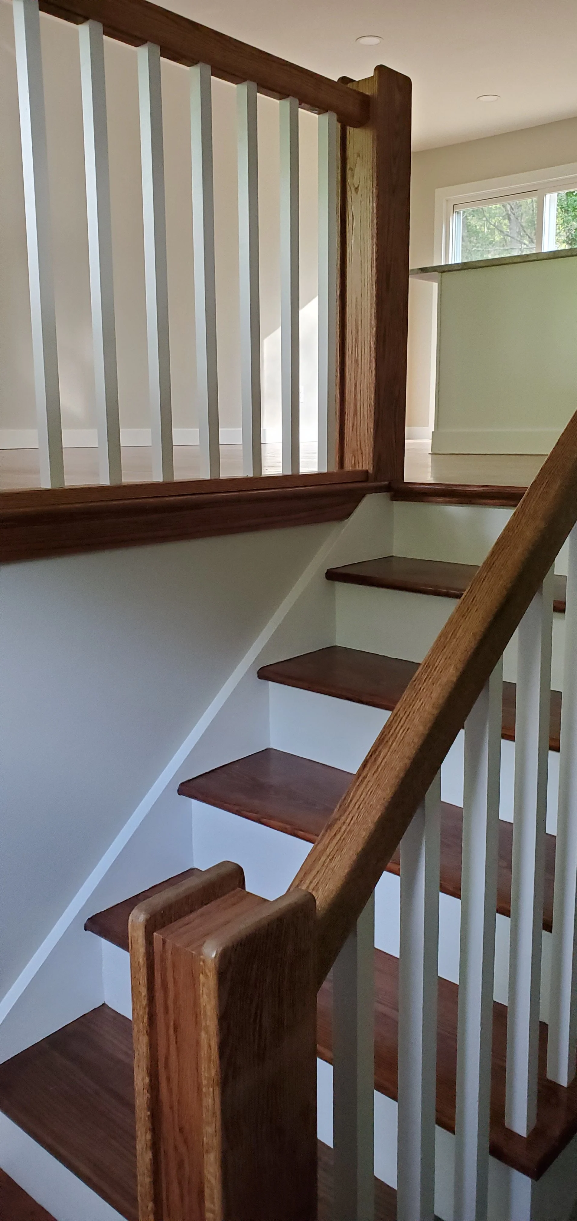 new oak railing painted spindles stained and poly top rail and newel posts, new oak treads with painted risers