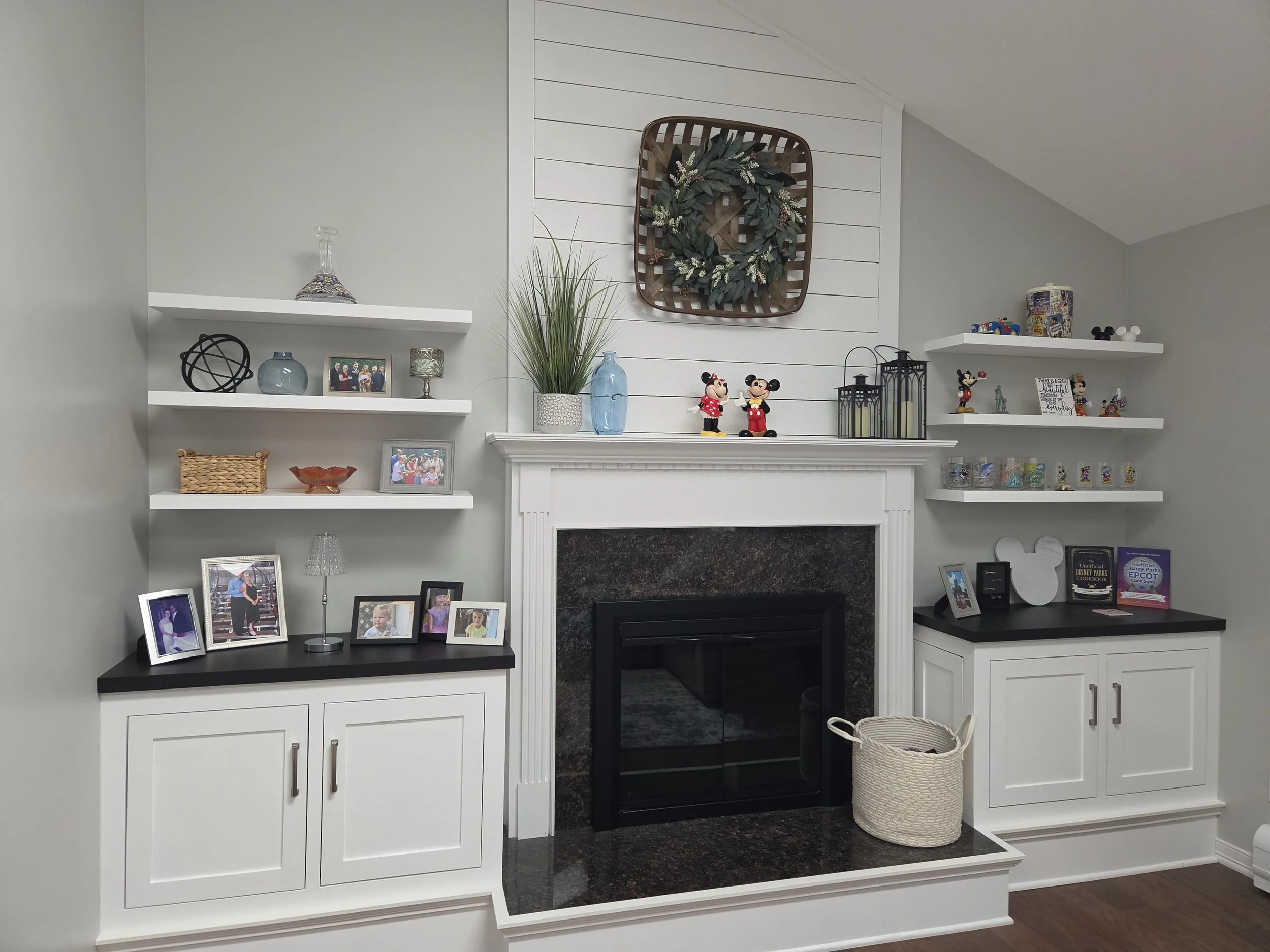 needed storage - inset hinges on doors, base same height as hearth ..six floating shelves ..black cabinet tops , matching fireplace and marble top of hearth