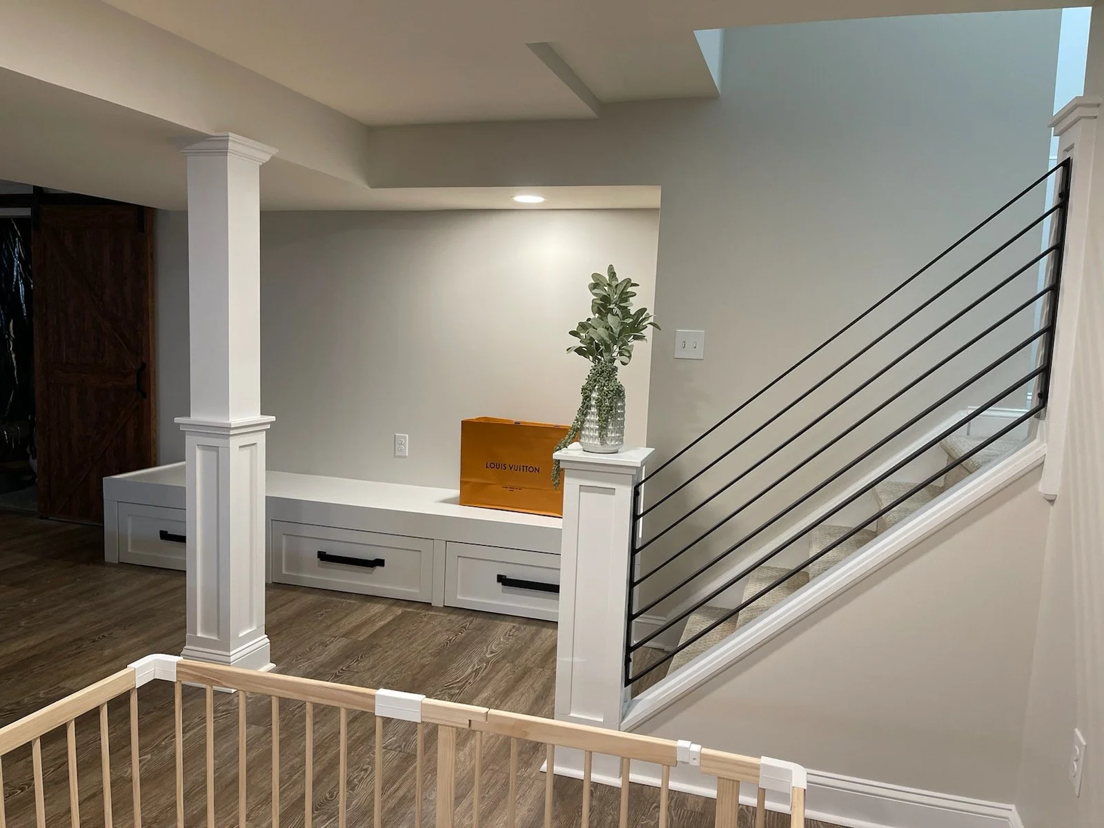  painted white built-in storage bench, with three full storage drawers, platform for cushioned as reading area