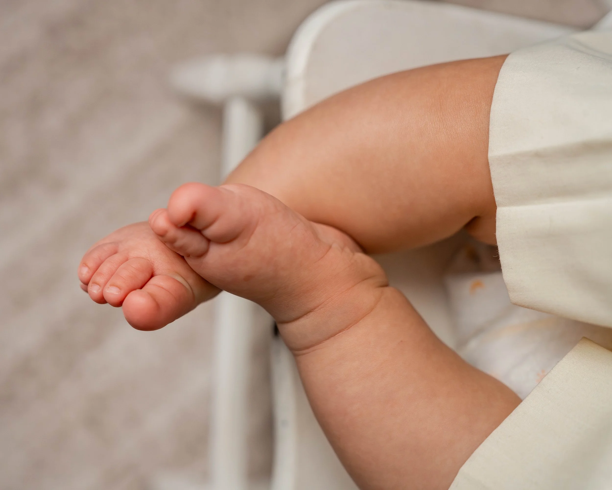 Baby girl's crossed feet