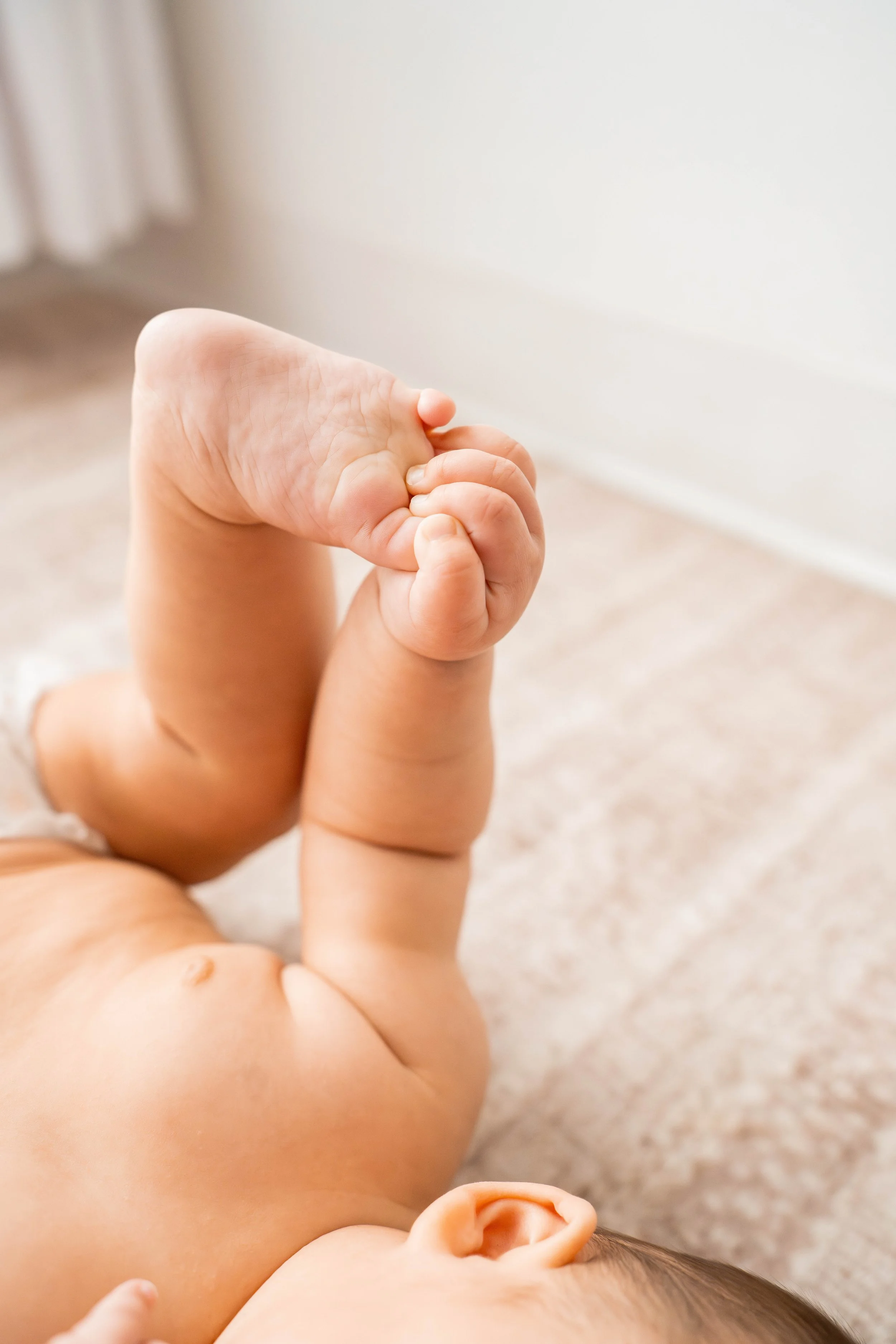 Baby grabbing their toes