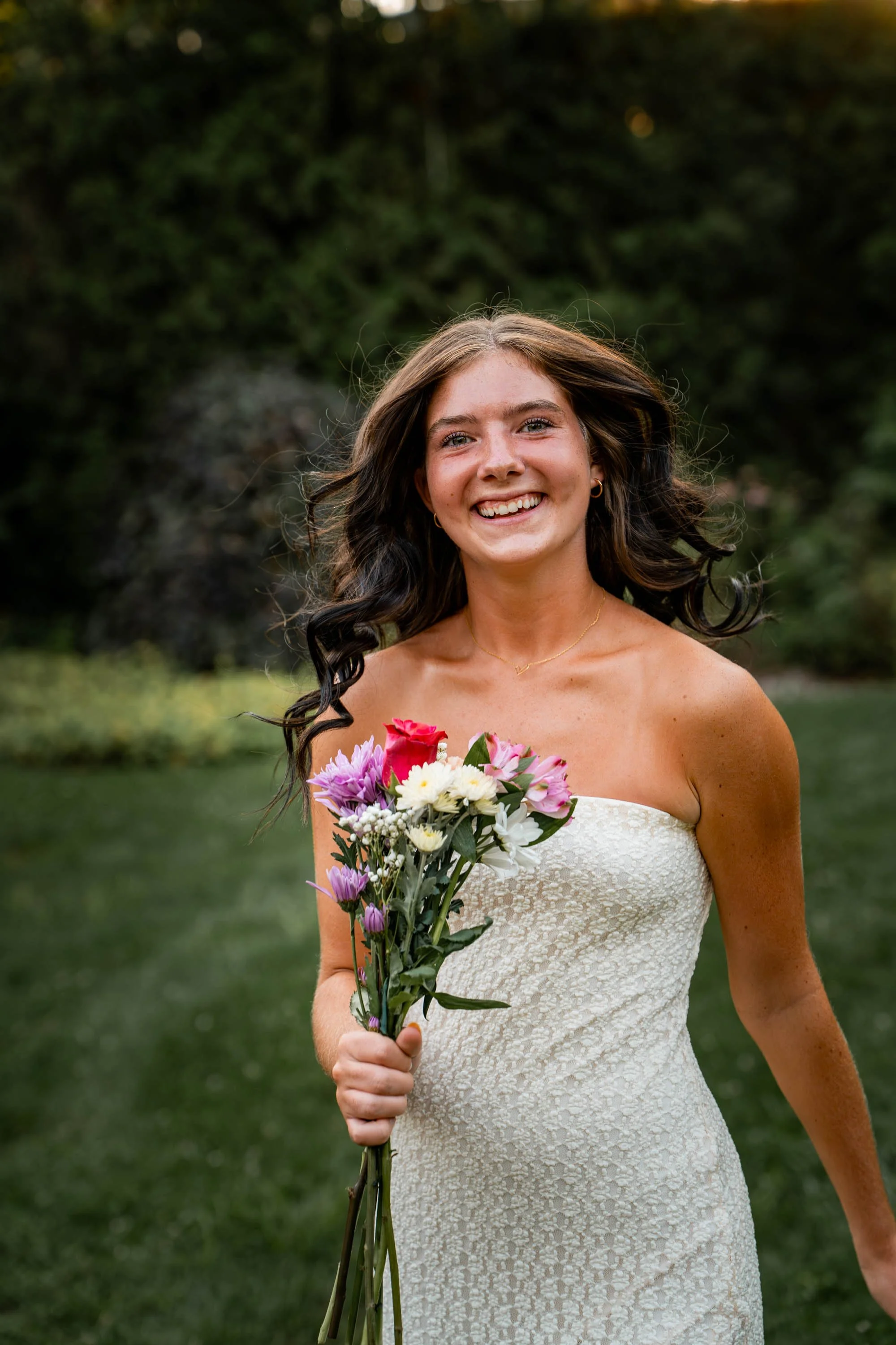 a girl in a white dress running with flowers and her hair flows through the wind