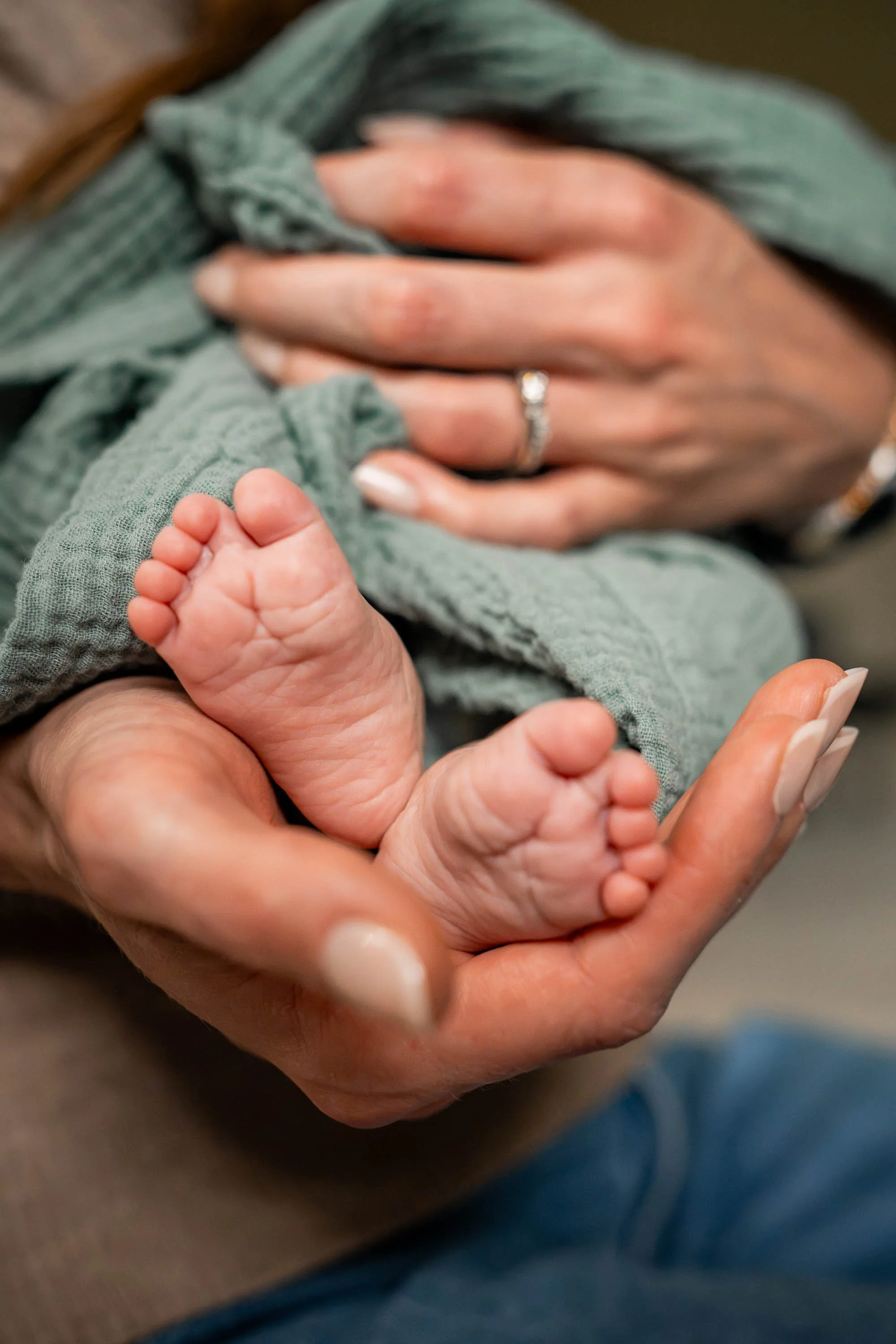Beavercreek mom holding new baby's feet
