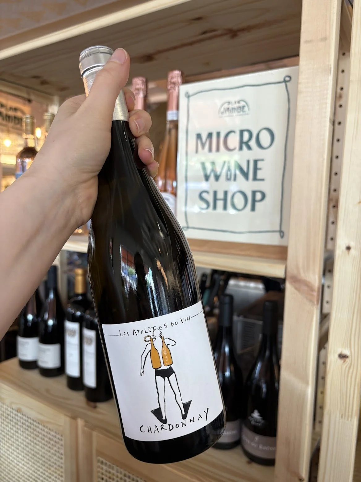 A bottle of Les Athlètes du Vin Chardonnay on a white background