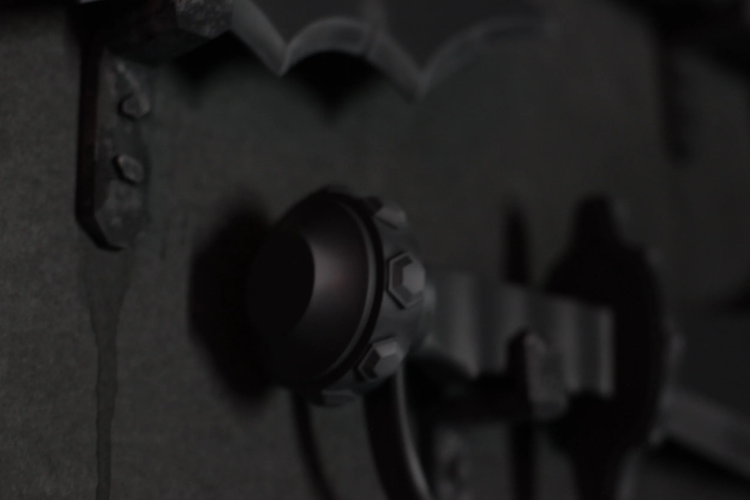 Close-up of a black firearm with a scope mounted on top inside of Atlas9.