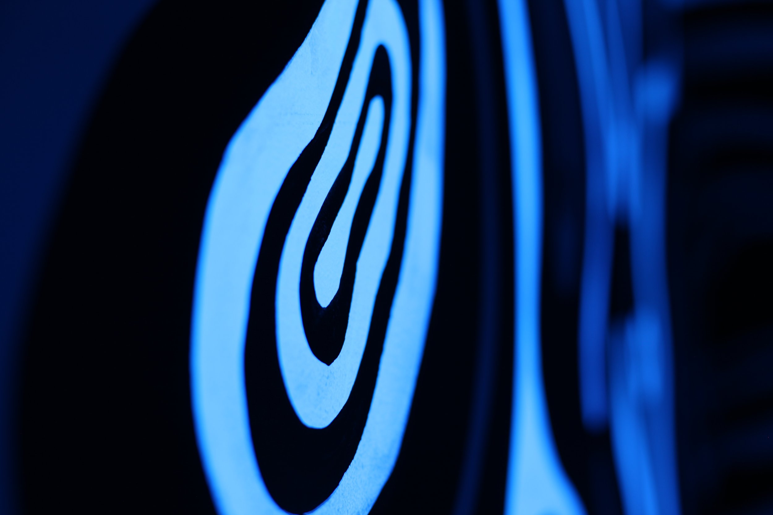 Close-up of a target symbol illuminated in blue light with concentric circles.