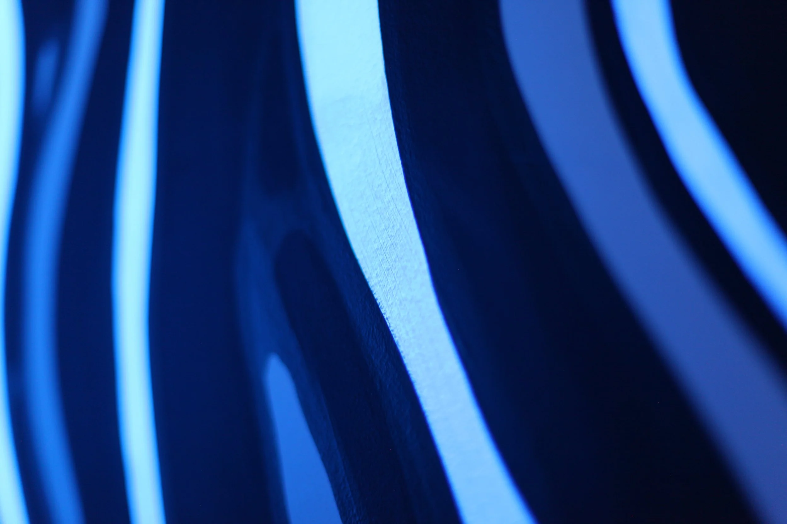 Close-up of illuminated blue LED light strips creating a pattern of glowing lines.