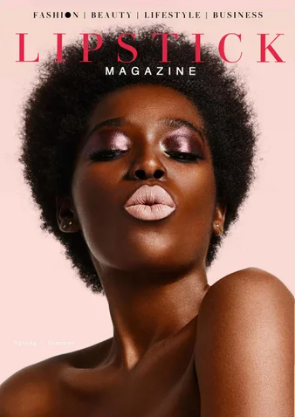 Close-up of a woman with natural hair and makeup, holding her shoulder, on the cover of Lipstick Magazine.