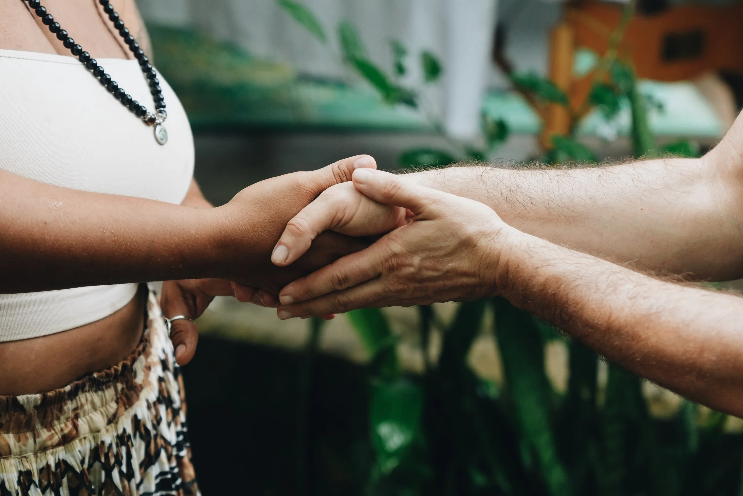 Two people holding hands in a supportive gesture.