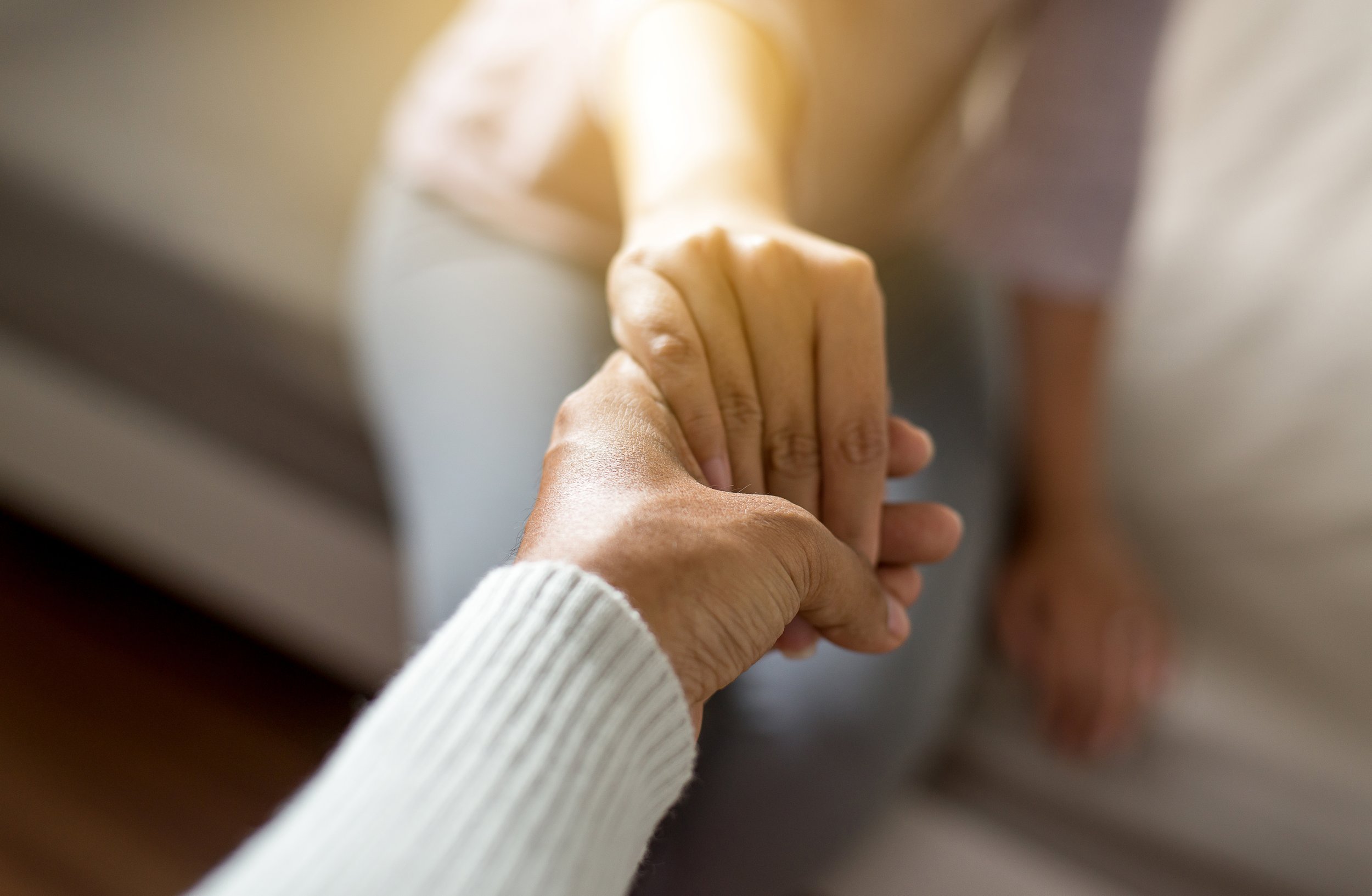 Picture of hands from two different people holding on to each other