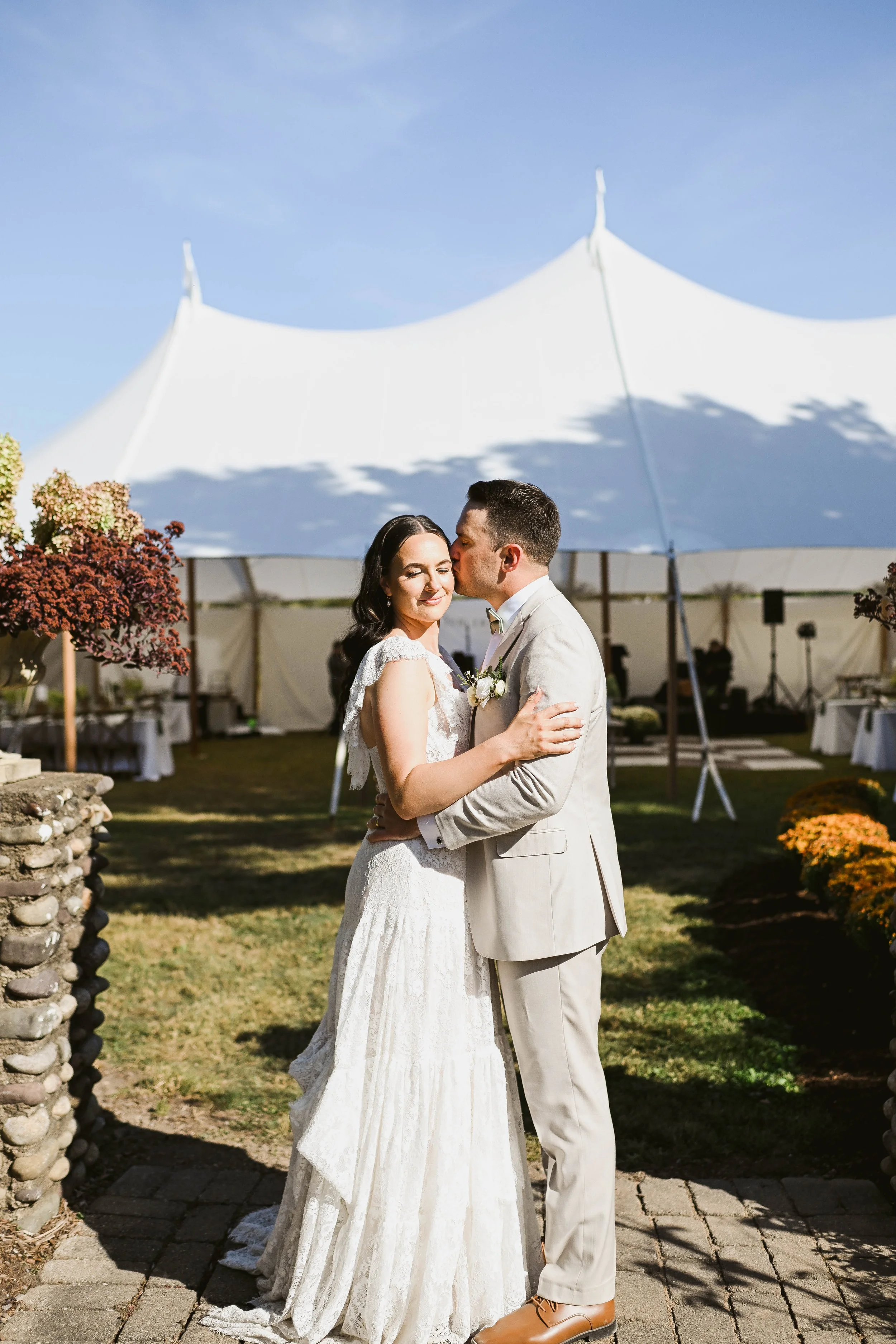 Bride and groom outside their tented, backyard wedding