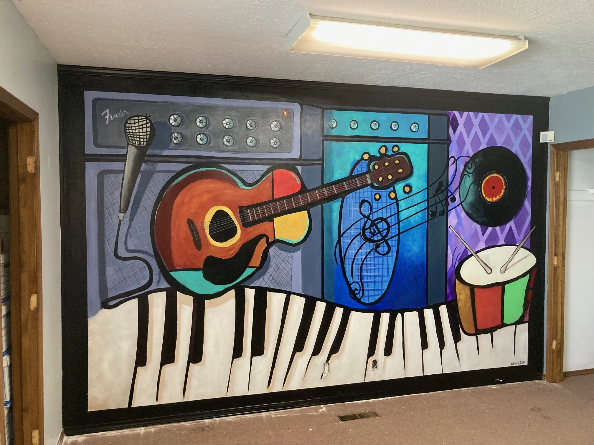 Colorful wall mural featuring musical instruments including a microphone, electric guitar, amplifier, a vinyl record, a drum, and piano keys.