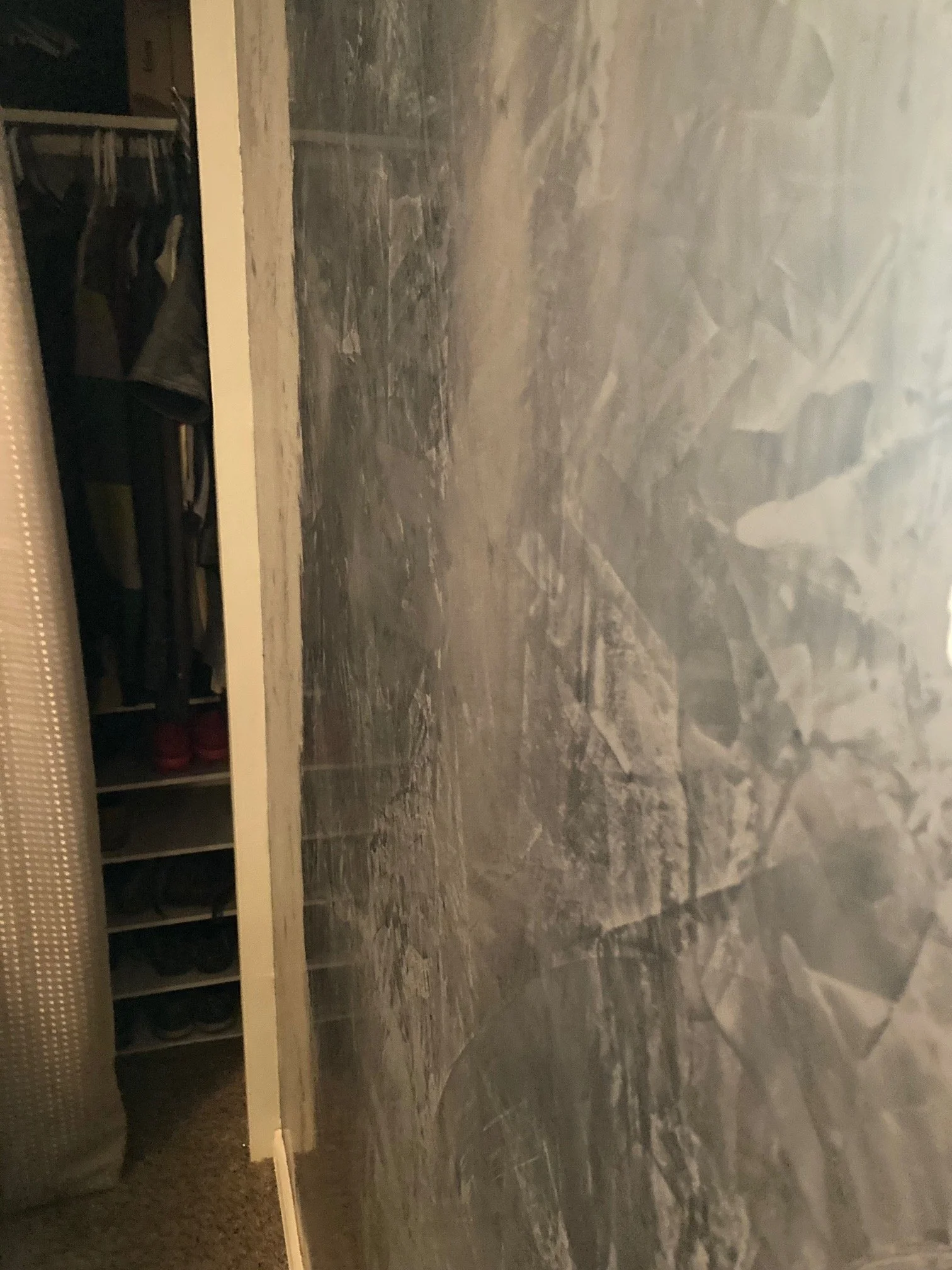 Close-up of a tiled floor with grayish and bluish tones, showing irregular stone patterns.