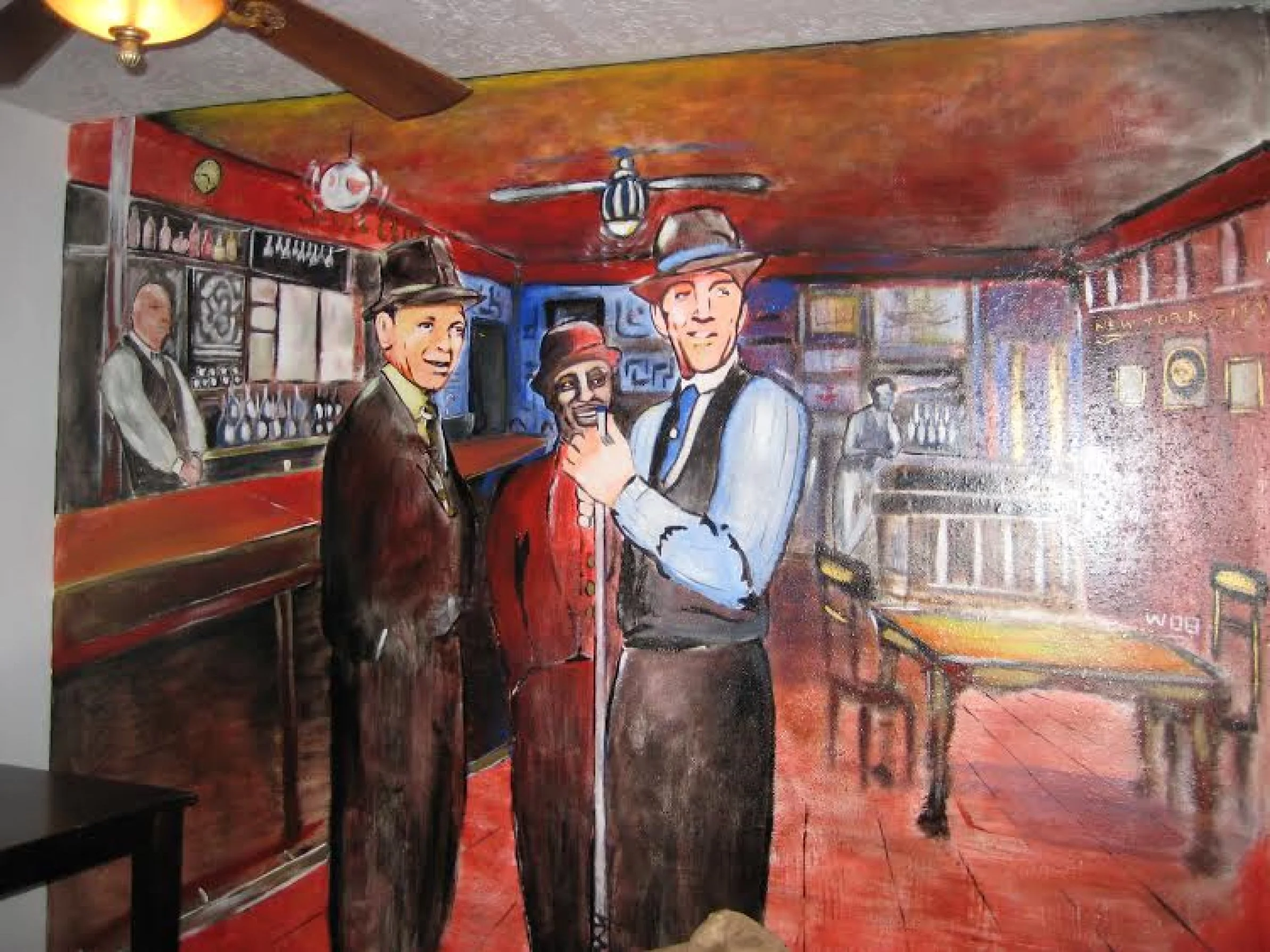 A colorful mural depicting a lively bar scene with three men in suits and hats in the foreground, a bartender behind the bar, and another person in the background. The style is cartoonish with exaggerated facial features.