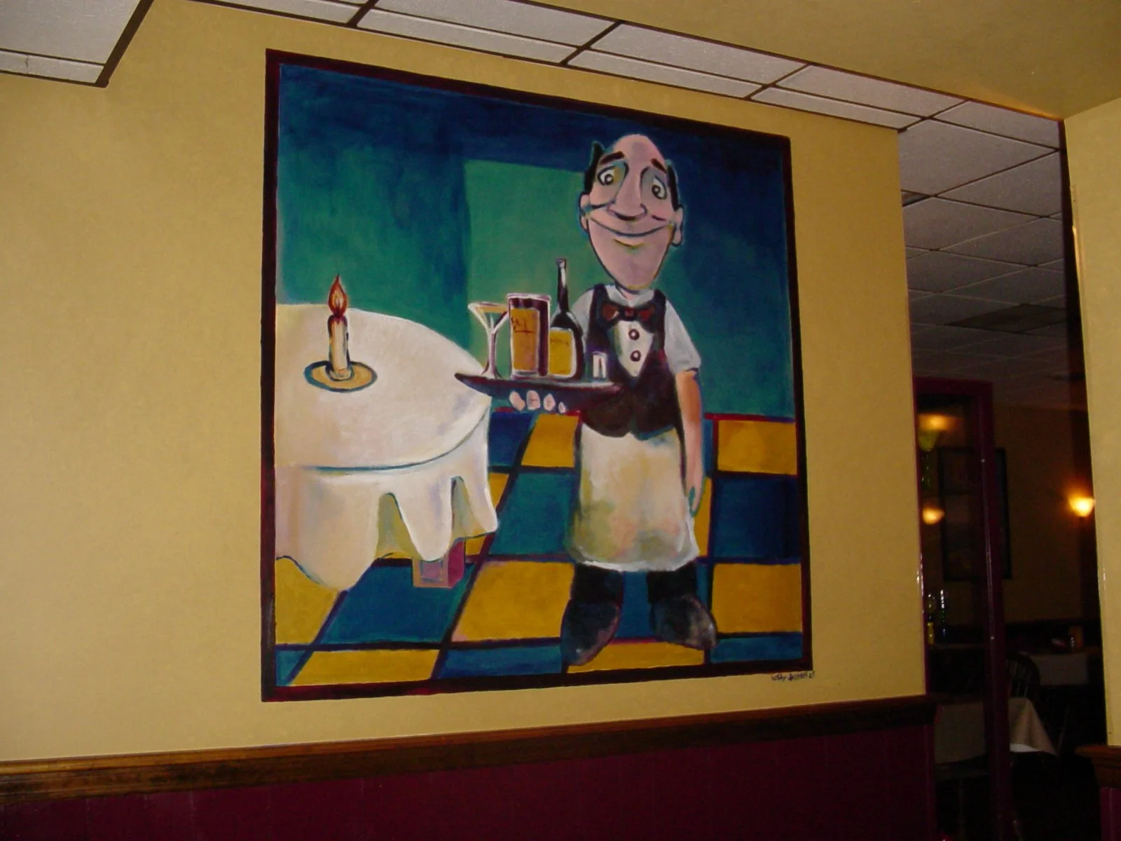 Colorful painting of a smiling waiter in a black vest, white shirt, and bow tie, carrying a tray with a bottle and glasses, standing in a restaurant with a table and lit candle in the background.