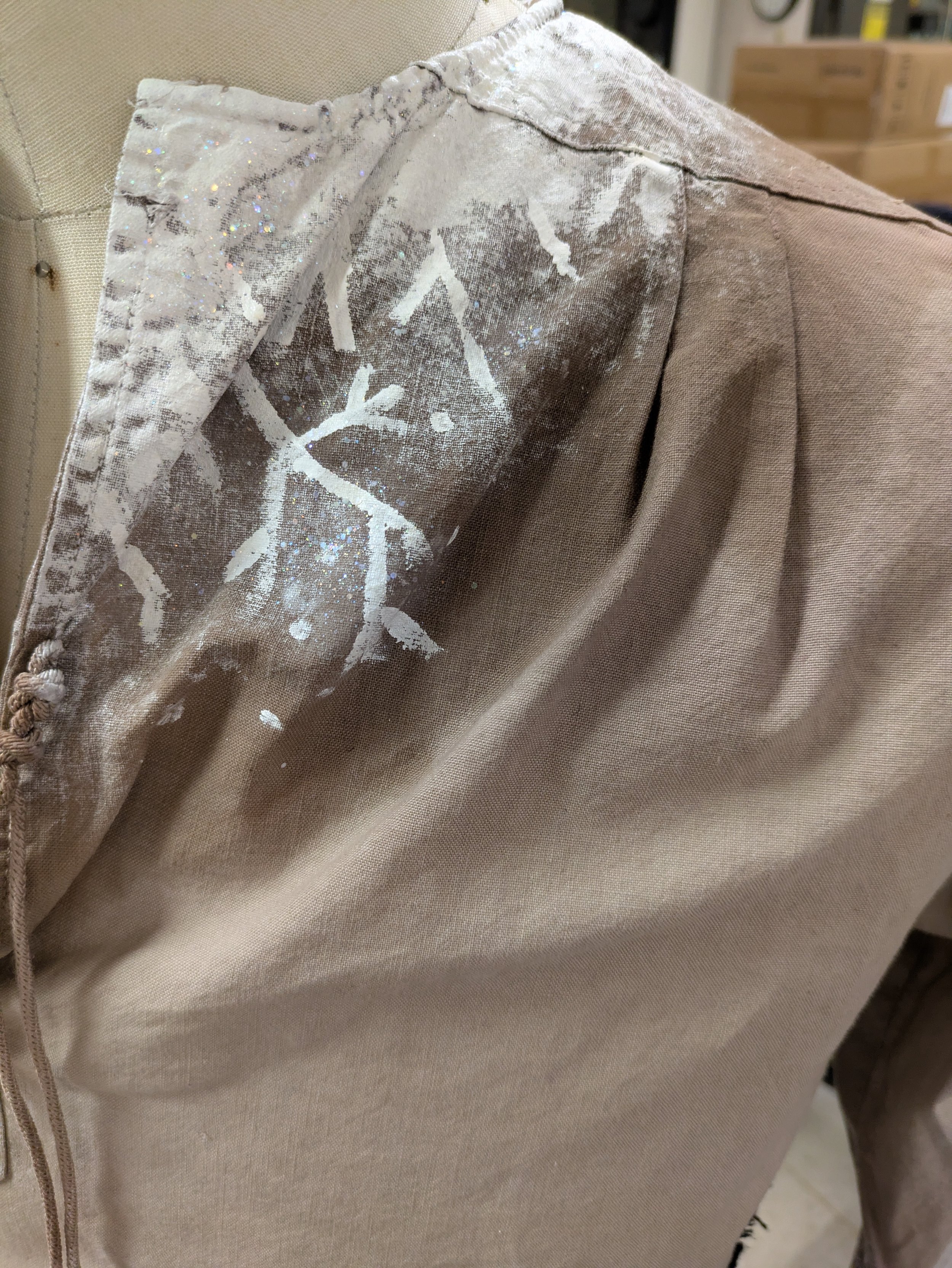 -The cloak is a Muslin poncho ombred using Black, Navy, and Purple RIT Dye with a faux fur collar.

-The tunic and pant were premade/ purchased and all distressed using watered down acrylic paints for sweat, mud, and age.

-Frost detail was hand pain