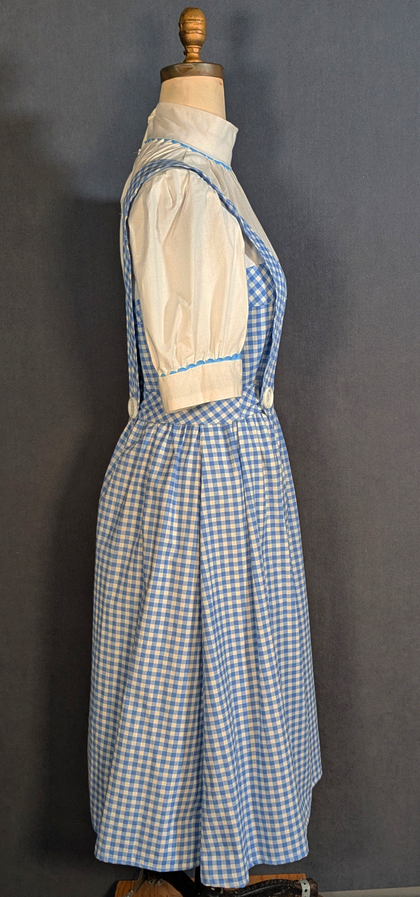 Based on the film version of the classic 'American Fairytale' The Wizard of Oz, this dressed was made using a hand draped and cut pattern. Materials: Blue Gingham Cotton-White Cotton- White Acrylic Buttons- White Acrylic Zipper- Blue Rick Rack