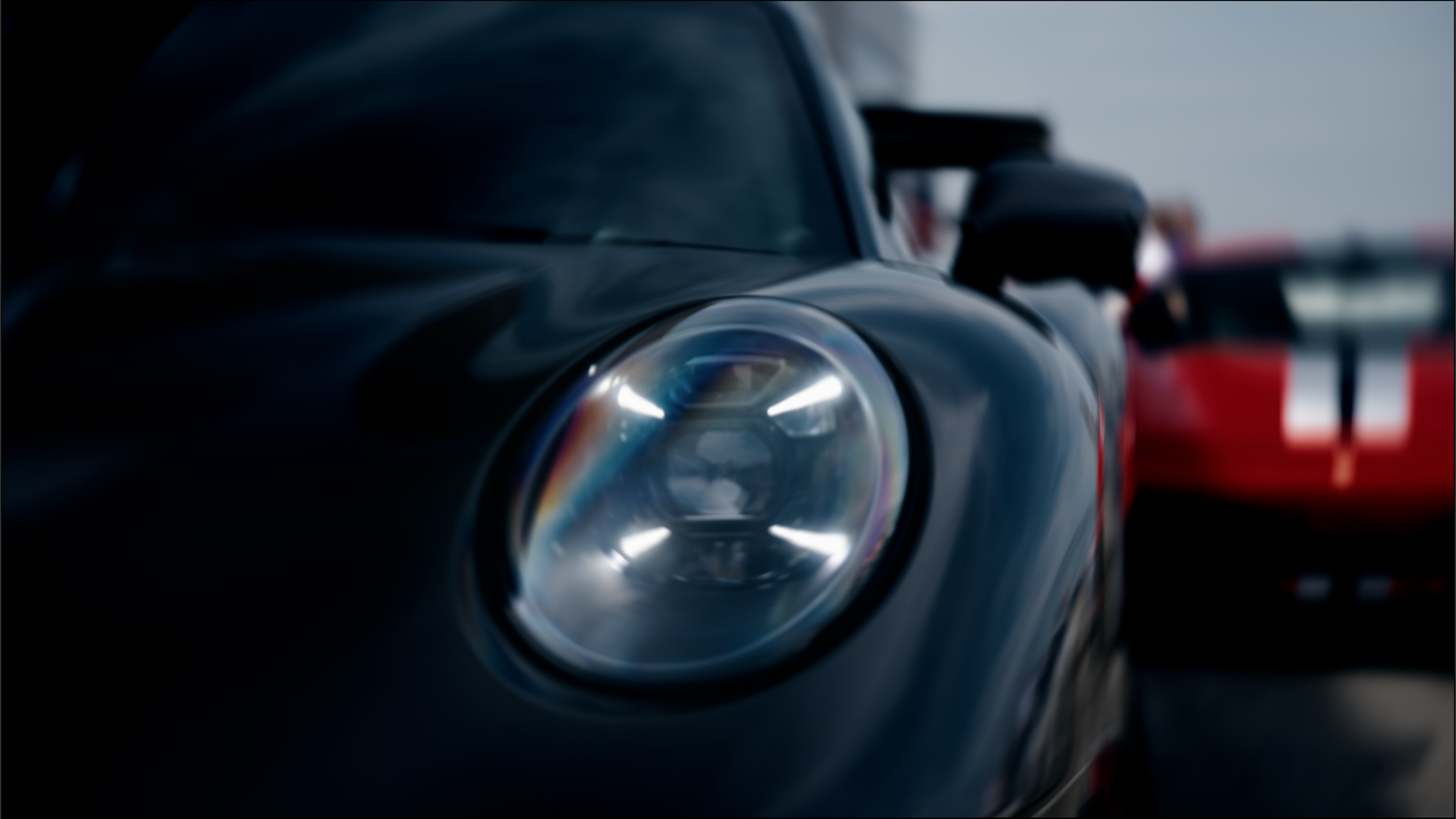Close-up of a sleek black sports car, focusing on its headlight and smooth body, with a red vehicle in the background and a person standing nearby.
