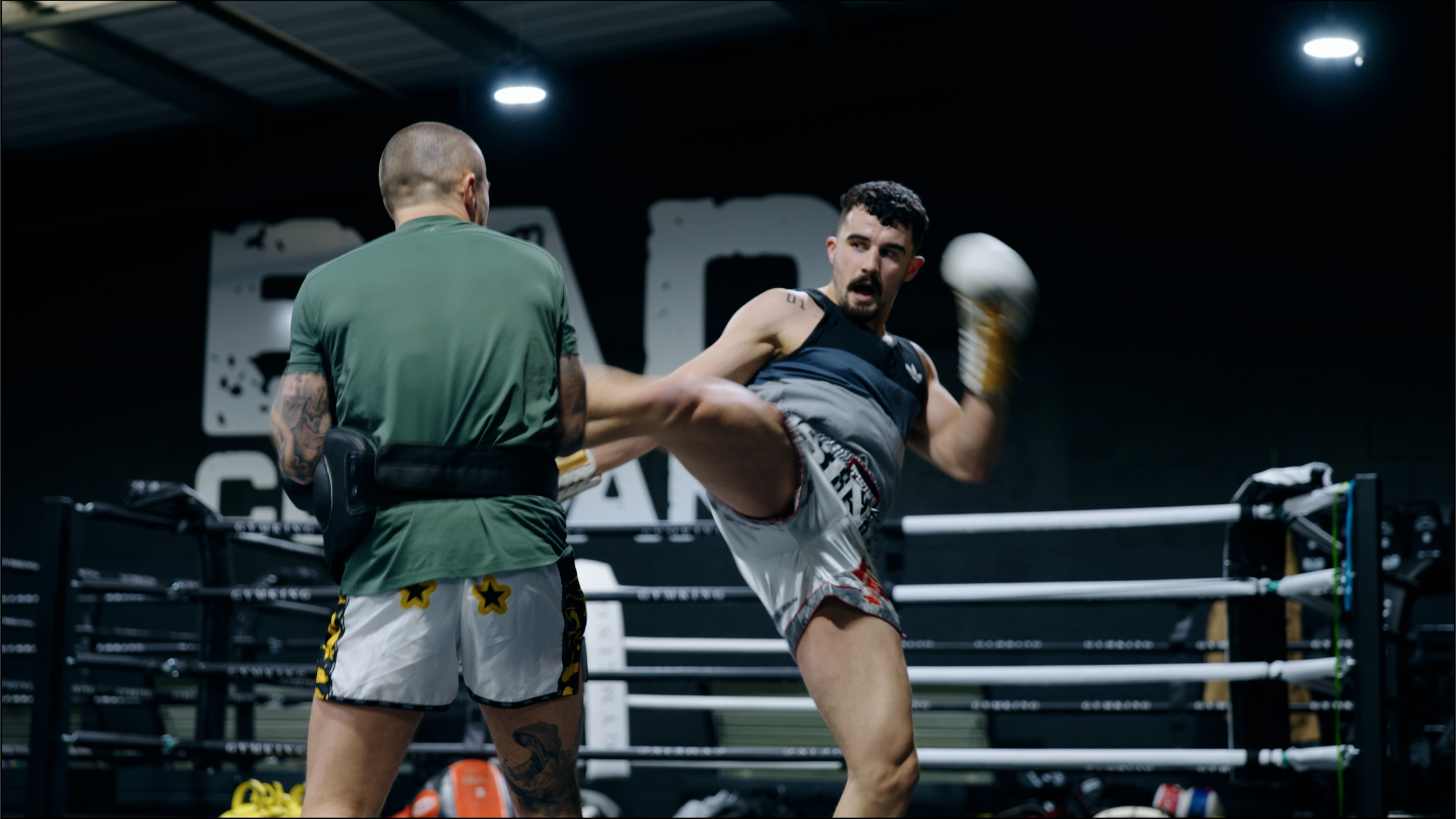 Muay Thai fighters practicing in the training ring.