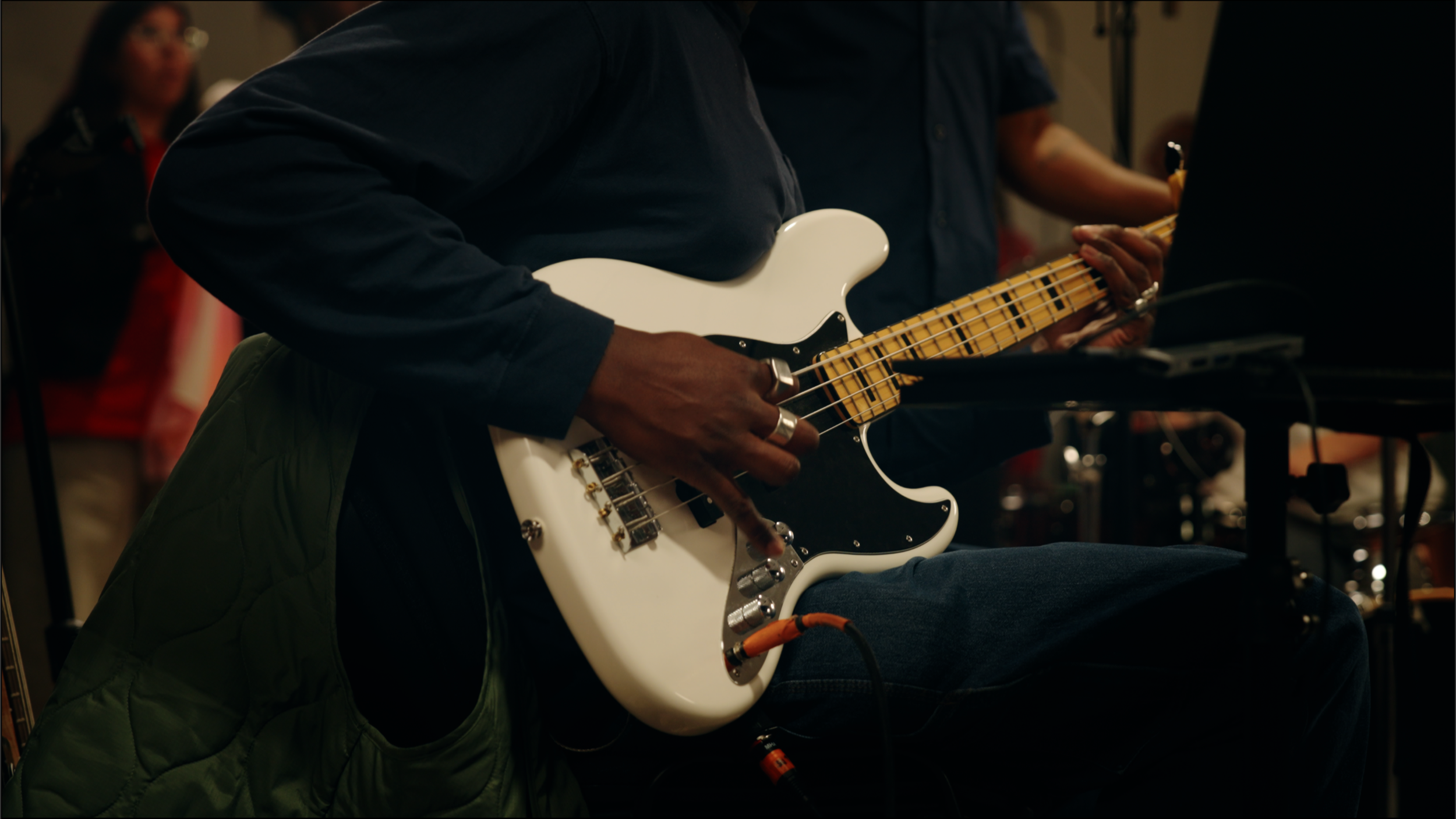 Person playing an electric guitar during a music session.