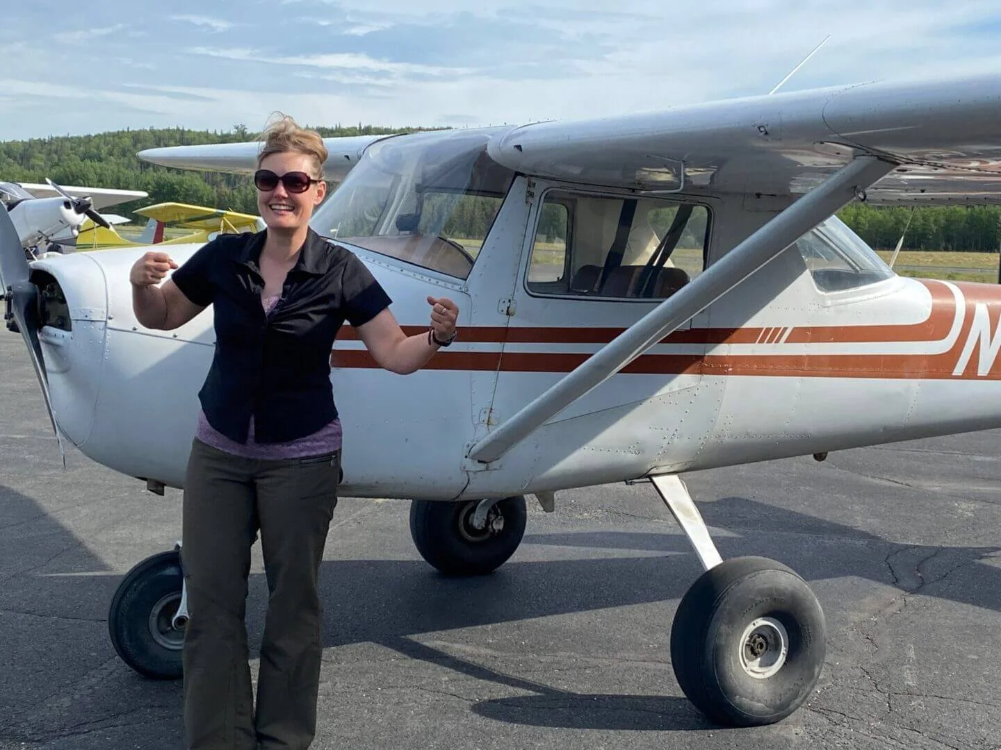 Female pilot standing in front of training aircraft at Alaska Float Training Sterling Alaska