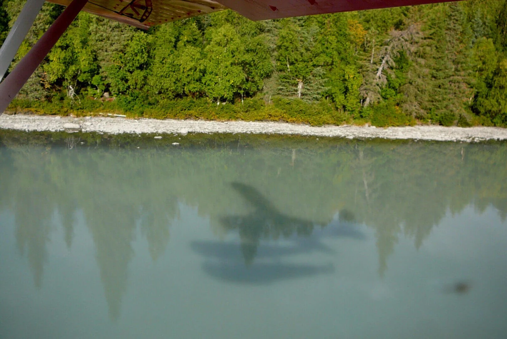 Float plane flying over Alaska lake during training flight at Alaska Float and Tailwheel Training