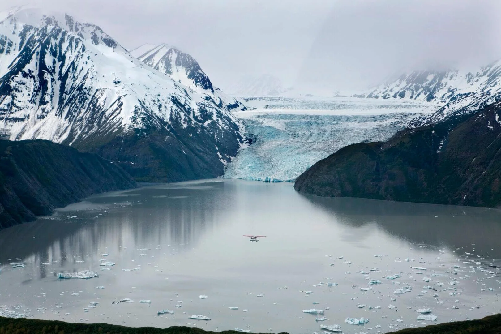 Float plane flying over Skilak Glacier and icebergs on Kenai Peninsula, scenic training flight Alaska