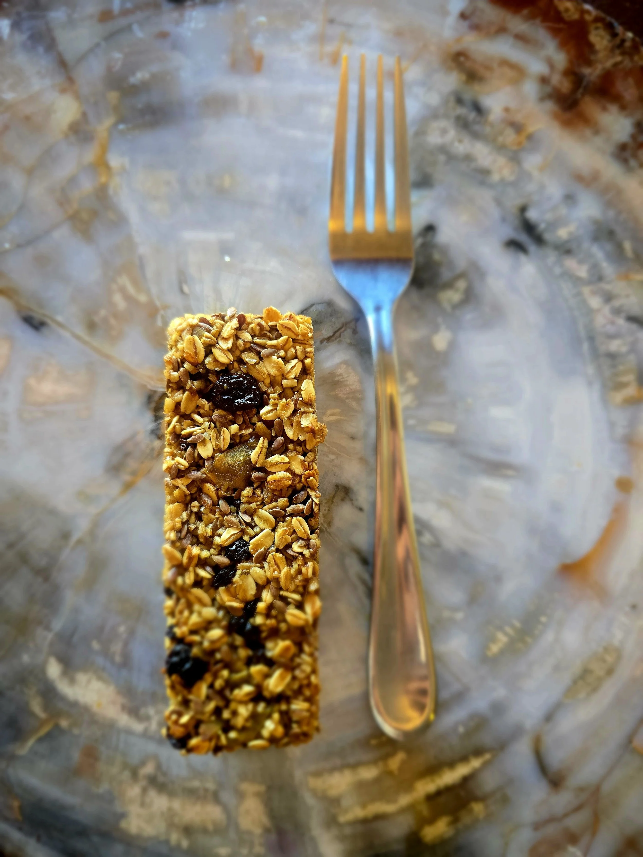 Chewy Oatmeal Raisin Granola Bar next to fork for size comparison
