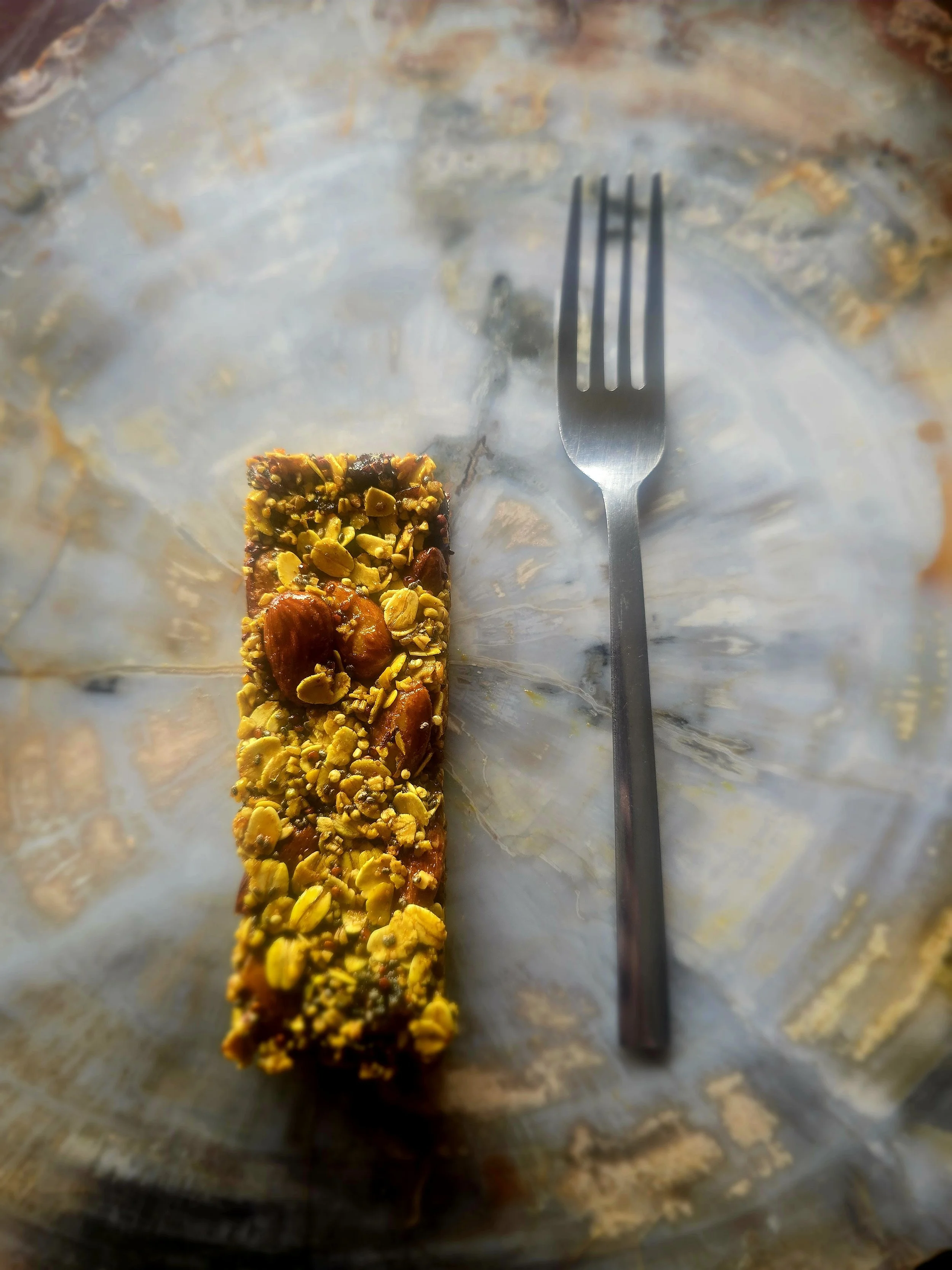 Chewy Cranberry Almond Granola Bar next to fork for size comparison