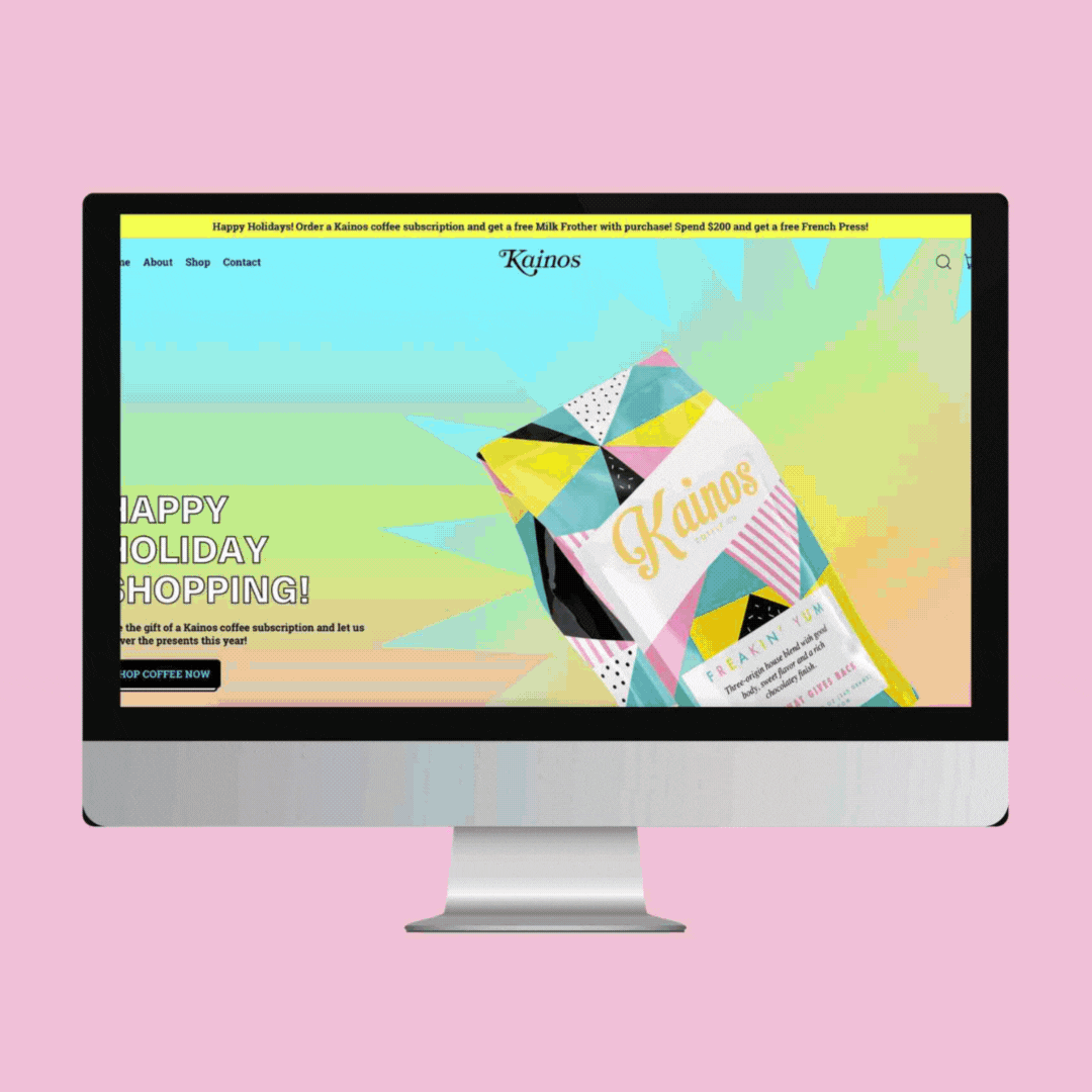Computer monitor displaying the homepage of Kajinos, a coffee subscription service, with a colorful geometric patterned coffee bag and a promotional banner at the top about holiday special offers.