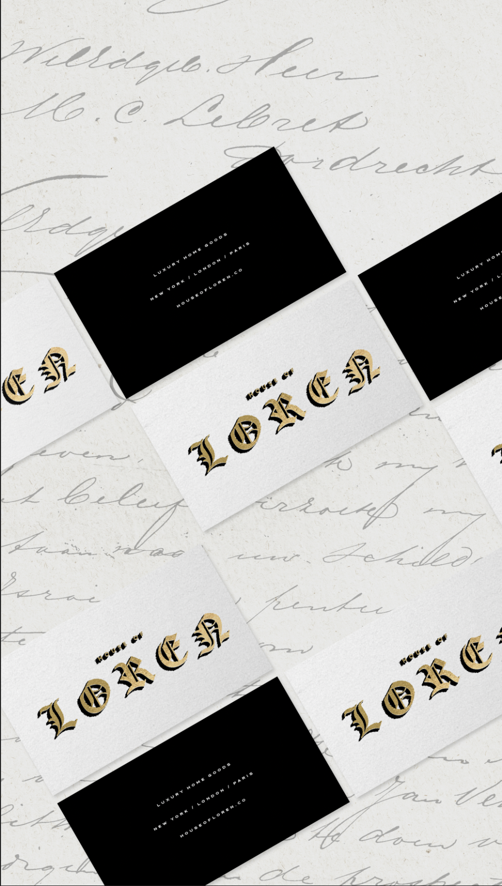 A collection of white and black cards with gold and black text, arranged on handwritten letter paper. The cards display the word "LORE" in gothic-style font and a slogan about luxury home goods. The handwritten letter has cursive writing in the background.