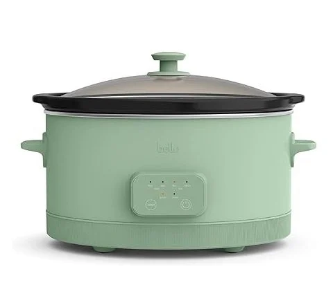 Mint green slow cooker with a glass lid and control panel on the front.