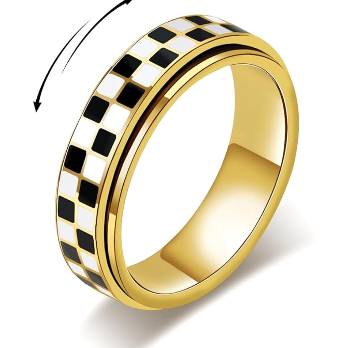 Gold ring with a black and white checkered pattern and an arrow indicating a rotating motion.