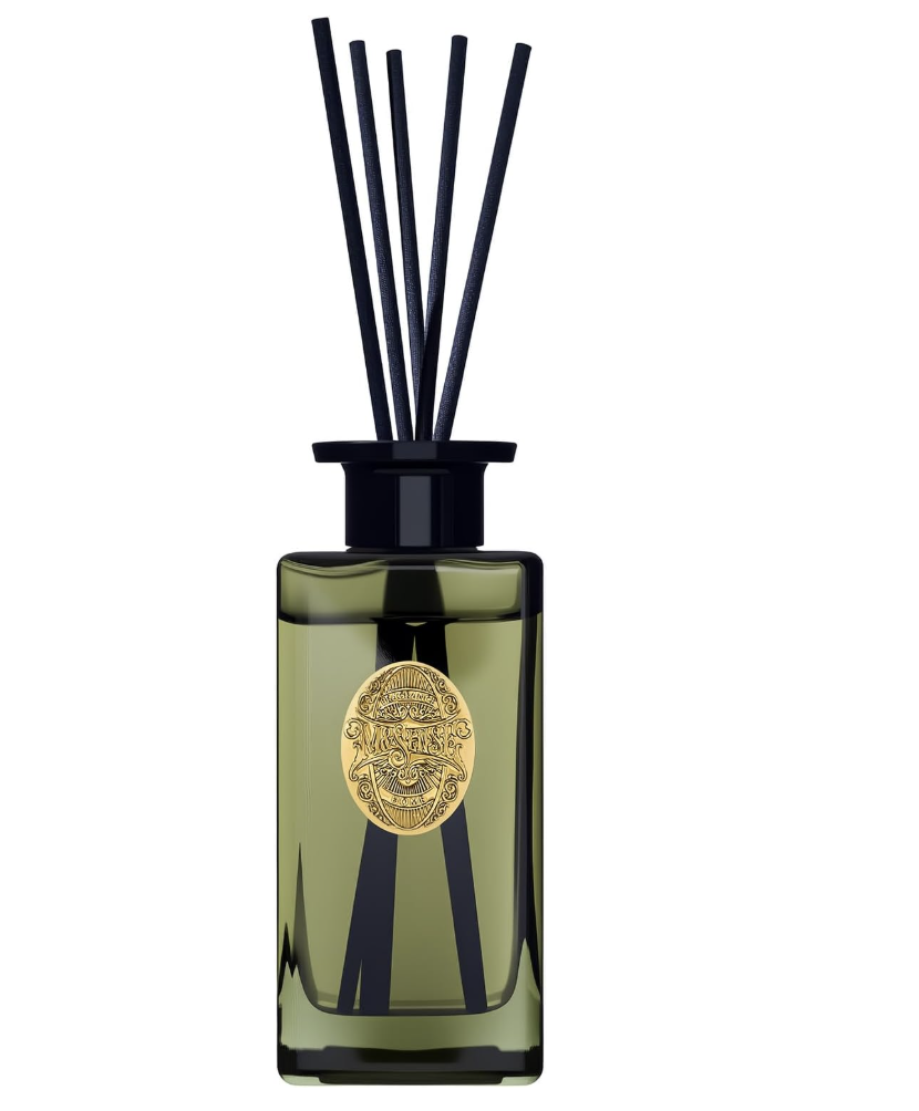 A green glass diffuser bottle with black reeds and a gold emblem on the front.