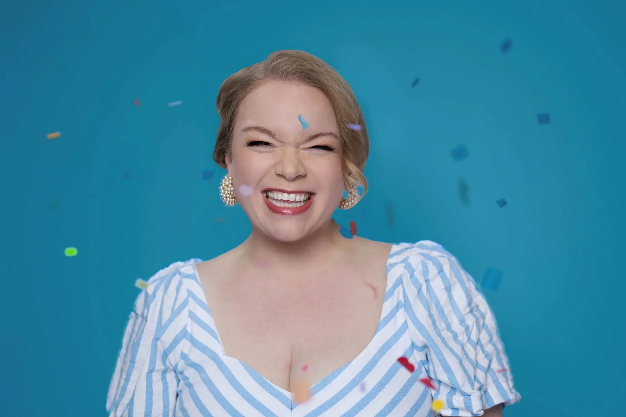 Jessie Hemmelgarn of Wonderline Creative, with colorful confetti falling around her, against a blue background.