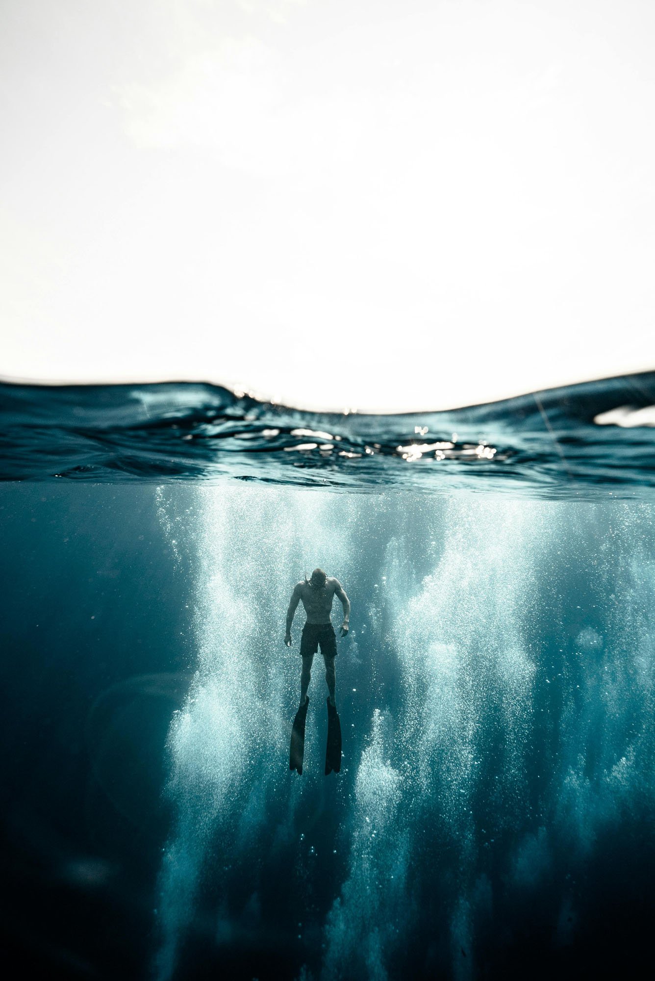 A diver moving upward toward the light, symbolizing clarity, momentum, and emerging insight; reflecting the Wonderline Creative DIVE process