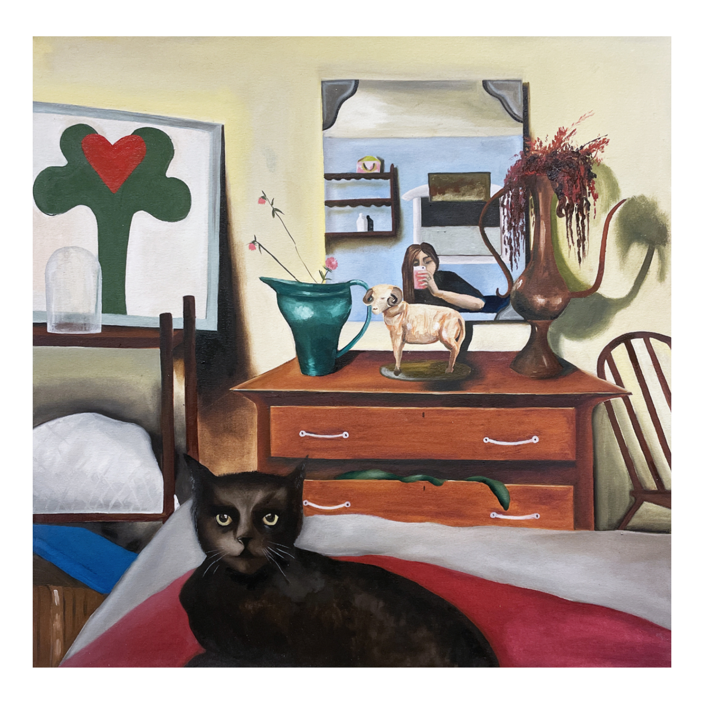 Interior of a room with a black cat in the foreground, a wooden dresser with decorative items including a small dog figurine, a large blue vase, and a tall brown vase with red flowers. A mirror reflects a woman taking a photo with her phone in an adjoining room. Artwork on the walls features abstract shapes and a tree with a red heart.