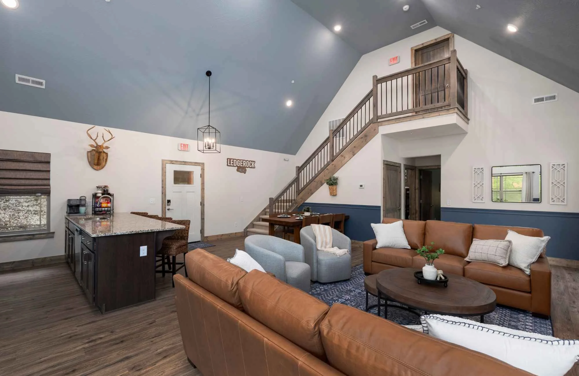 full-service-interior-design-blue-eye-mo-choosing-colors-for-your-home-open-concept-lake-house-leather-sofas-blue-ceiling-open-staircase-thoughtful-remodel.jpg