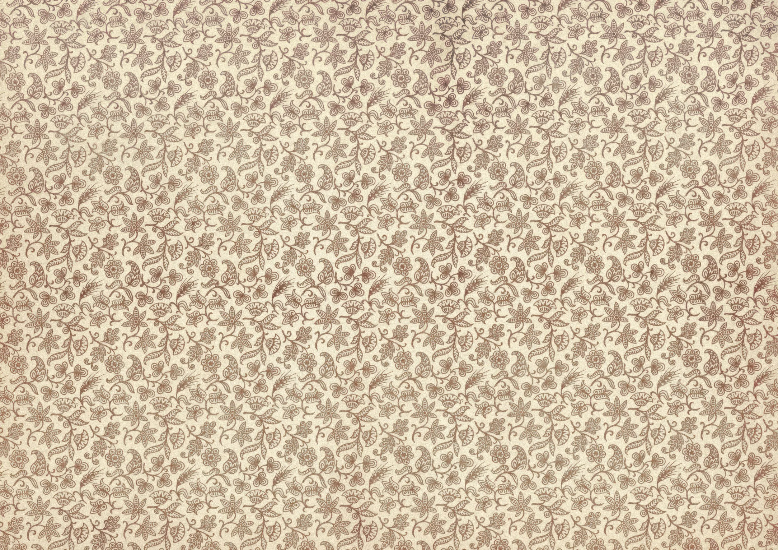 A patterned beige and brown wallpaper with floral and leaf motifs.