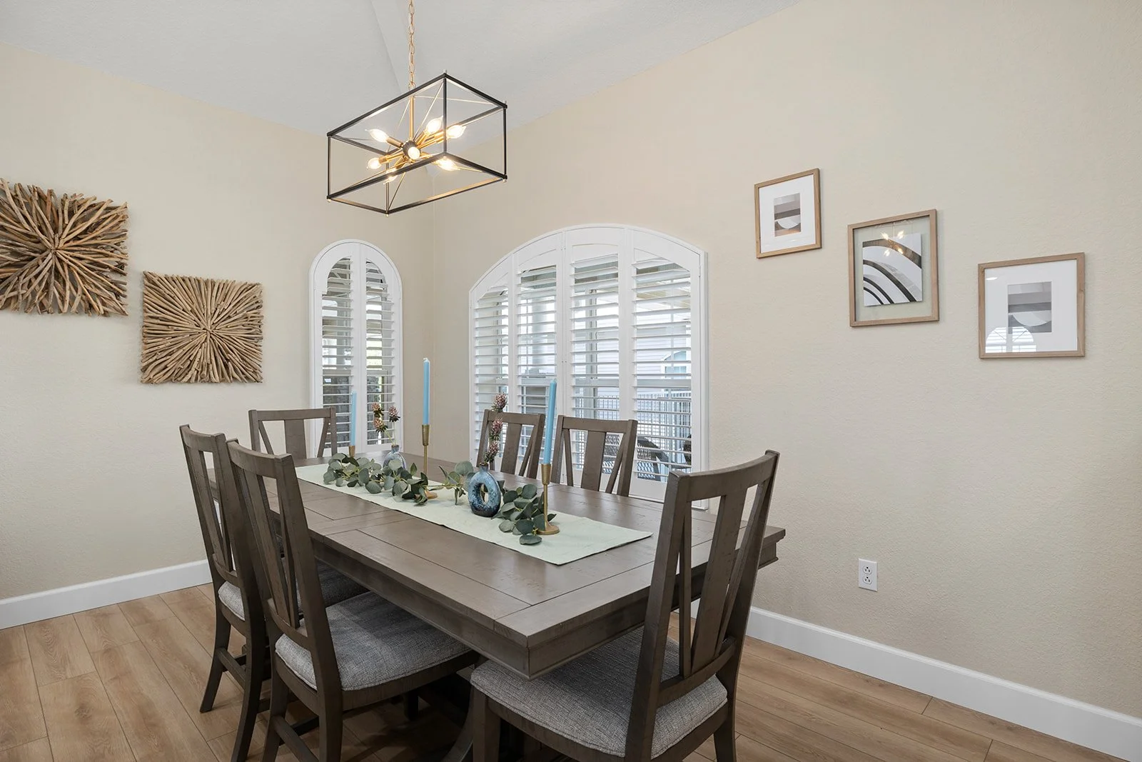 holly-jones-signature-homes-branson-mo-ready-to-hire-interior-designer-dining-room-dark-wood-rectangular-table-and-chairs-arched-windows-neutral-colors.jpg
